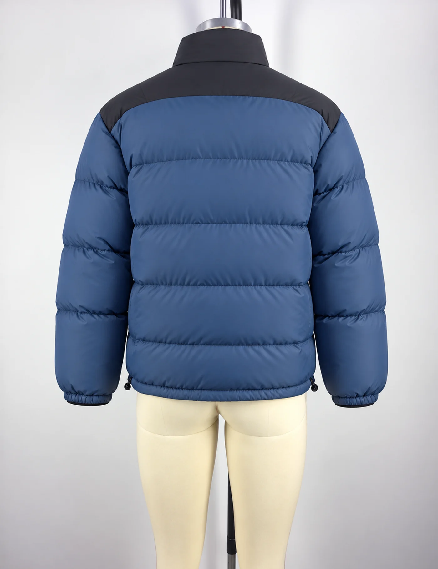 Actual lightweight color-block puffer jacket sample shown from the back on a mannequin
