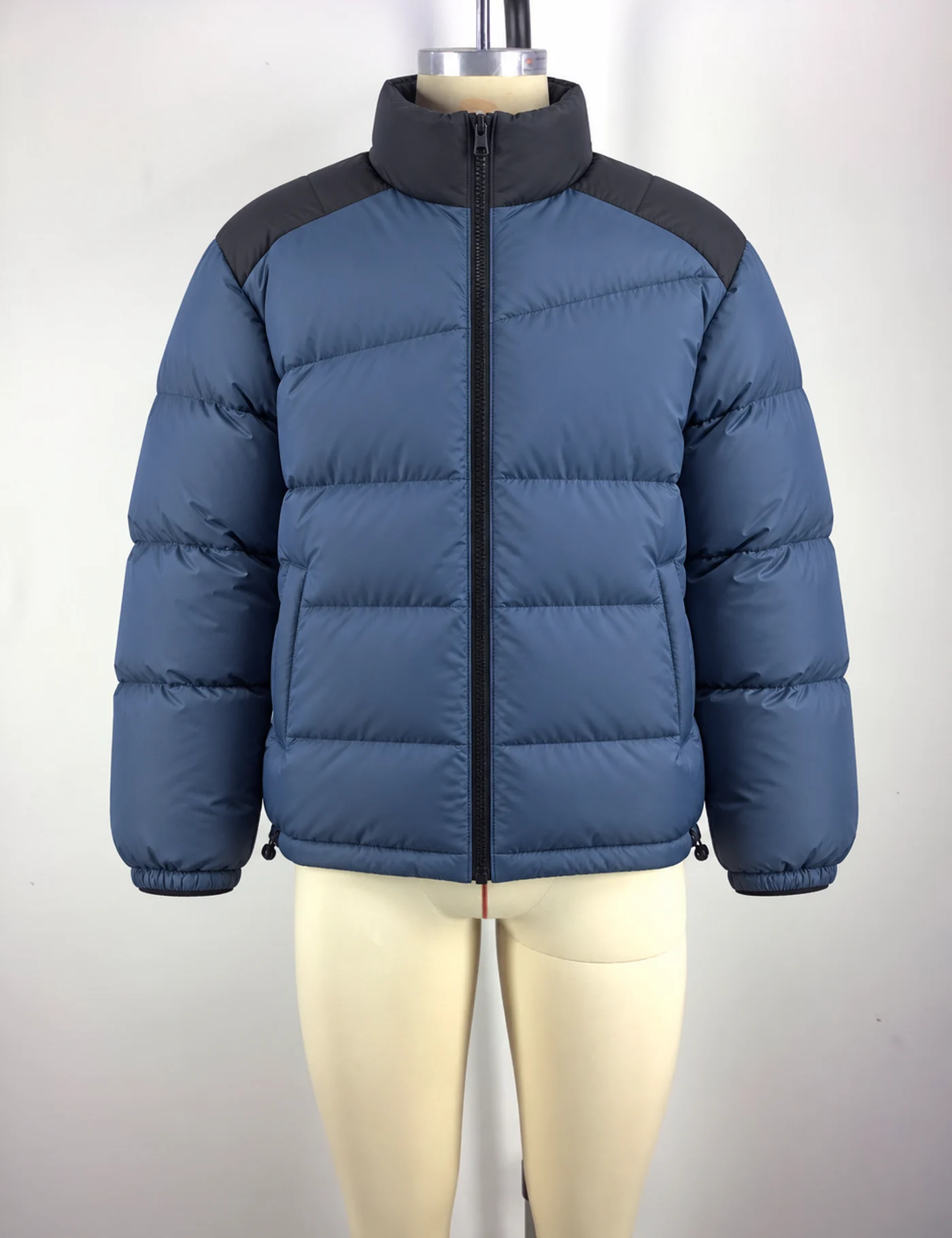 Actual lightweight color-block puffer jacket sample shown from the front on a mannequin