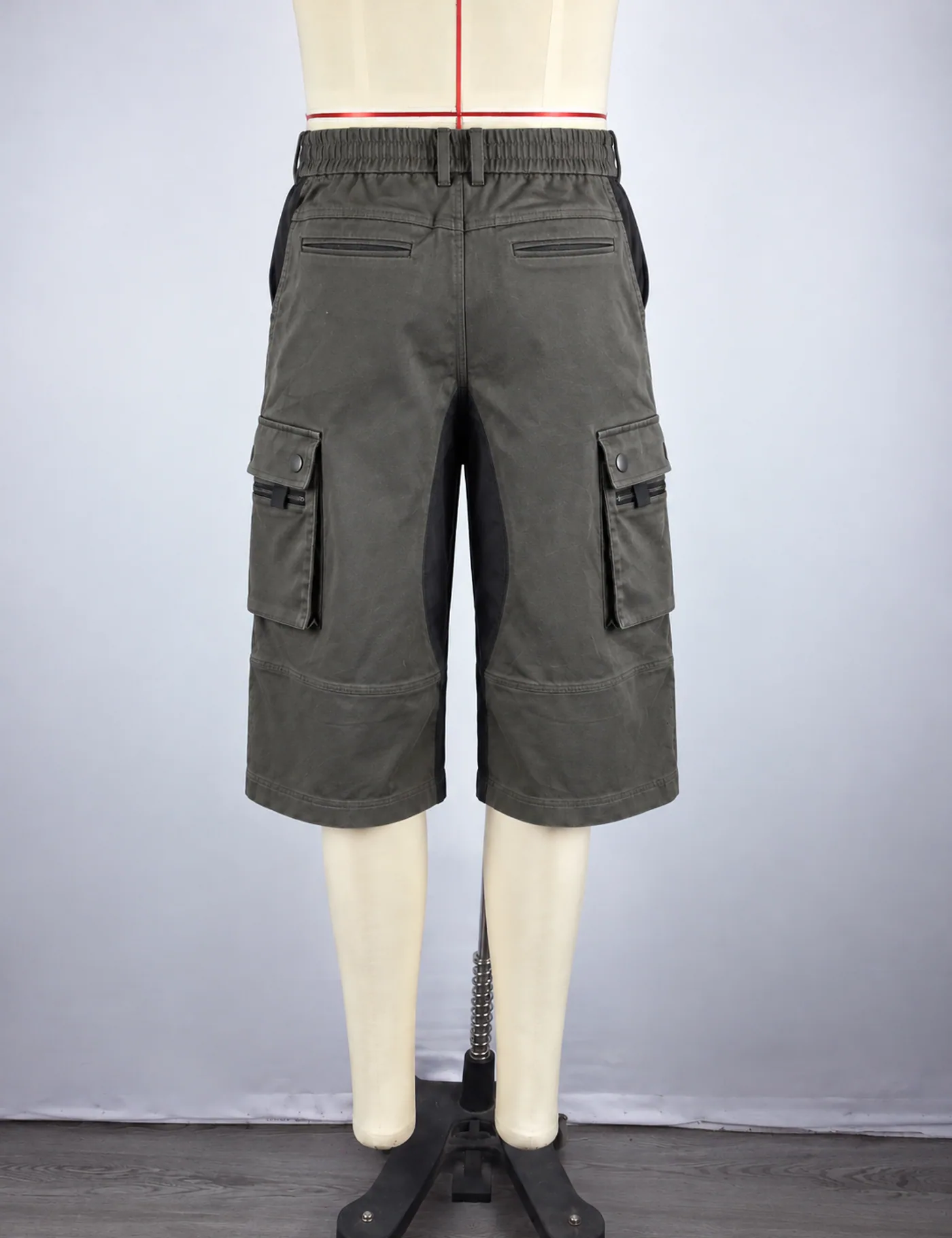 Actual multi-pocket belted cargo shorts sample shown from the back on a mannequin