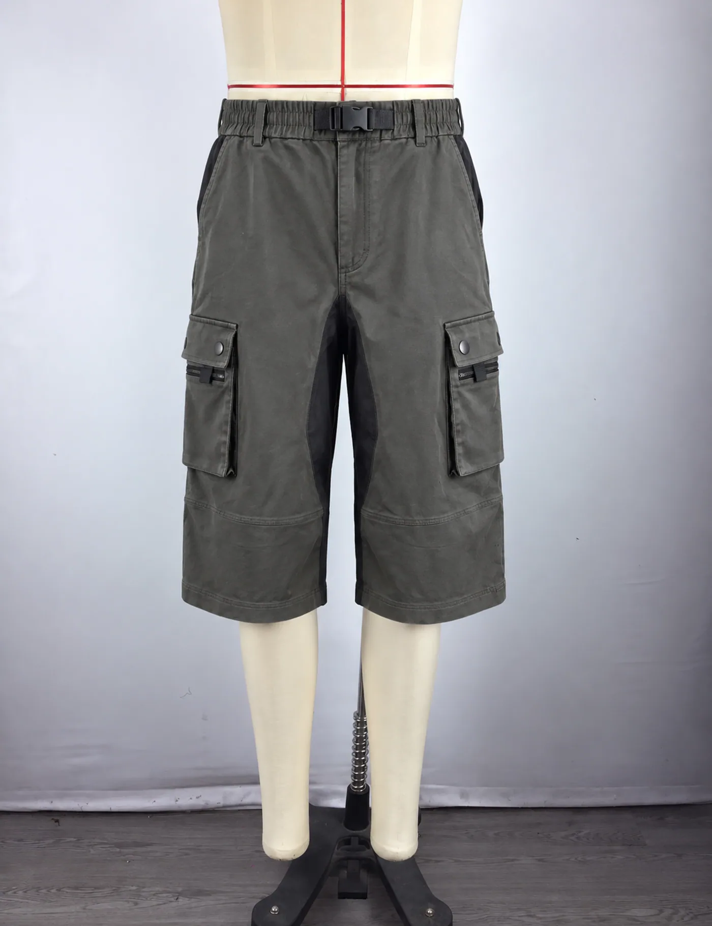 Actual multi-pocket belted cargo shorts sample shown from the front on a mannequin