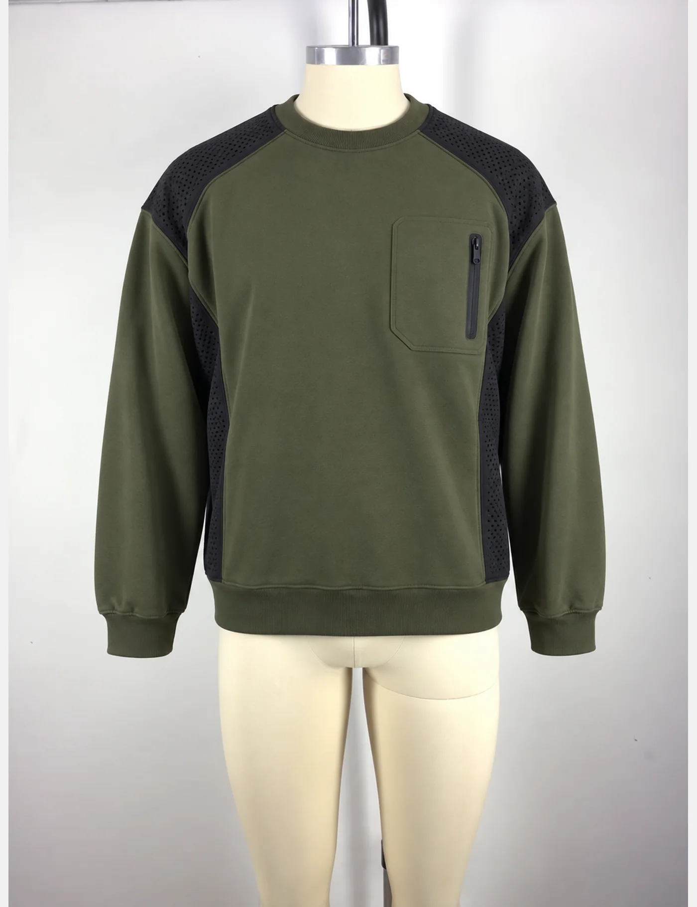 Actual perforated-panel utility crewneck sweatshirt sample shown from the front on a mannequin