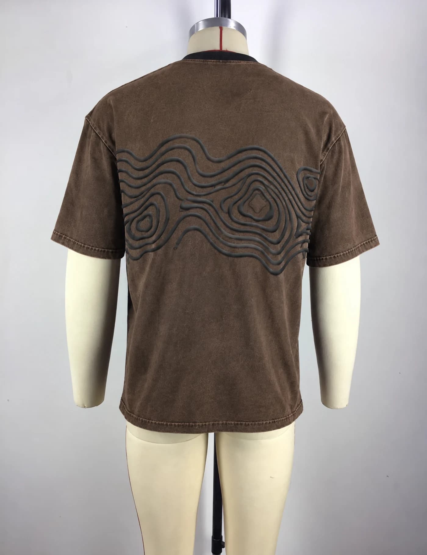 Actual raised-cord embroidered oversized t-shirt sample shown from the back on a mannequin