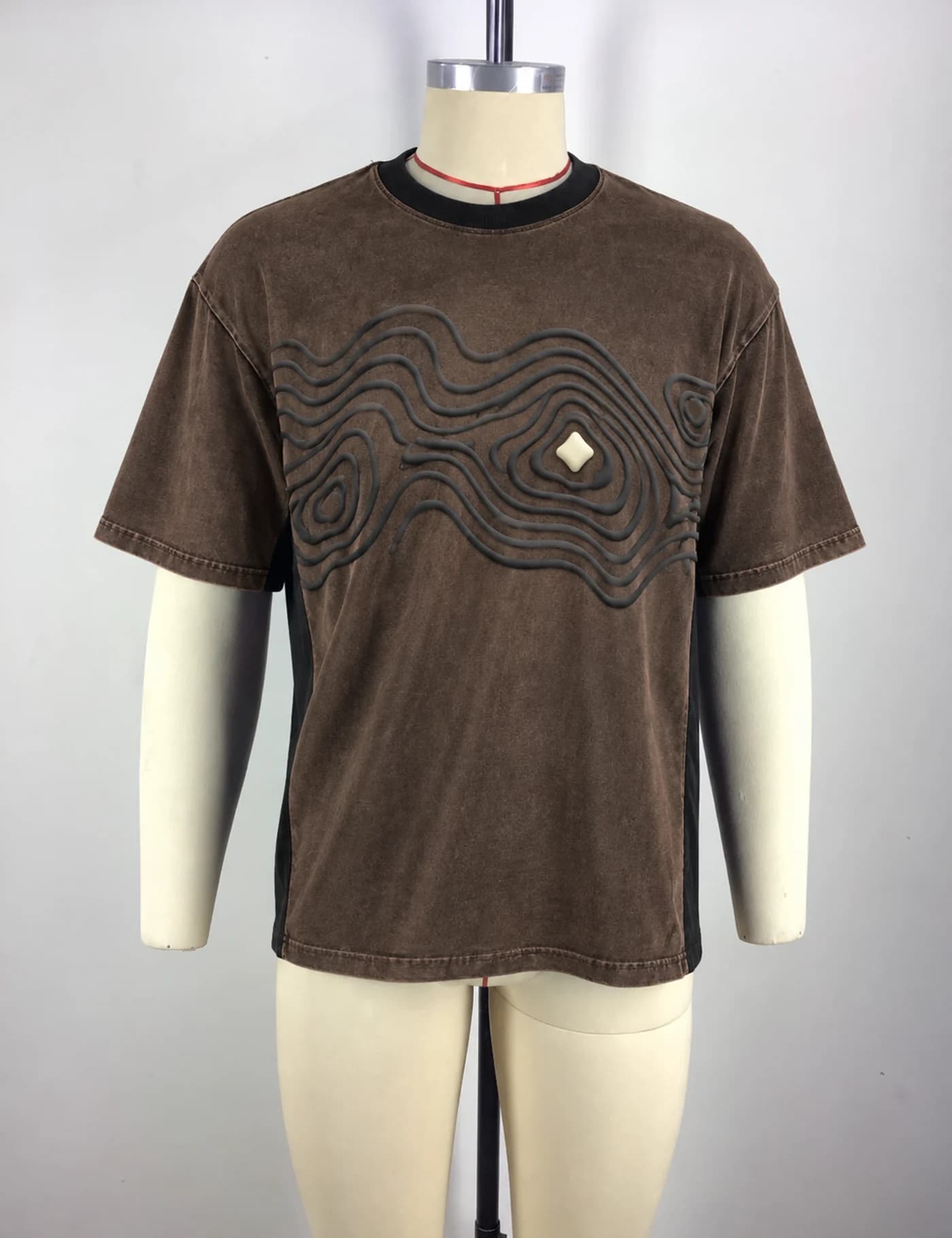 Actual raised-cord embroidered oversized t-shirt sample shown from the front on a mannequin