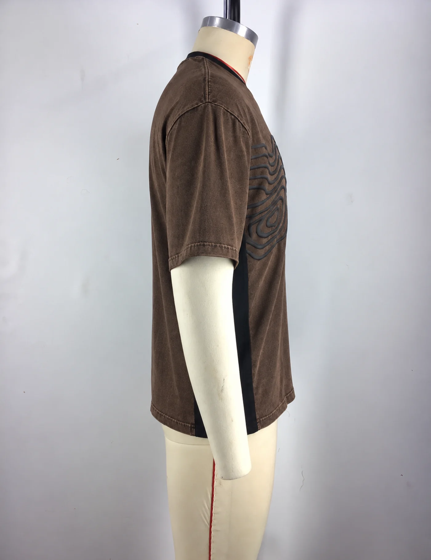 Actual raised-cord embroidered oversized t-shirt sample shown from the side on a mannequin