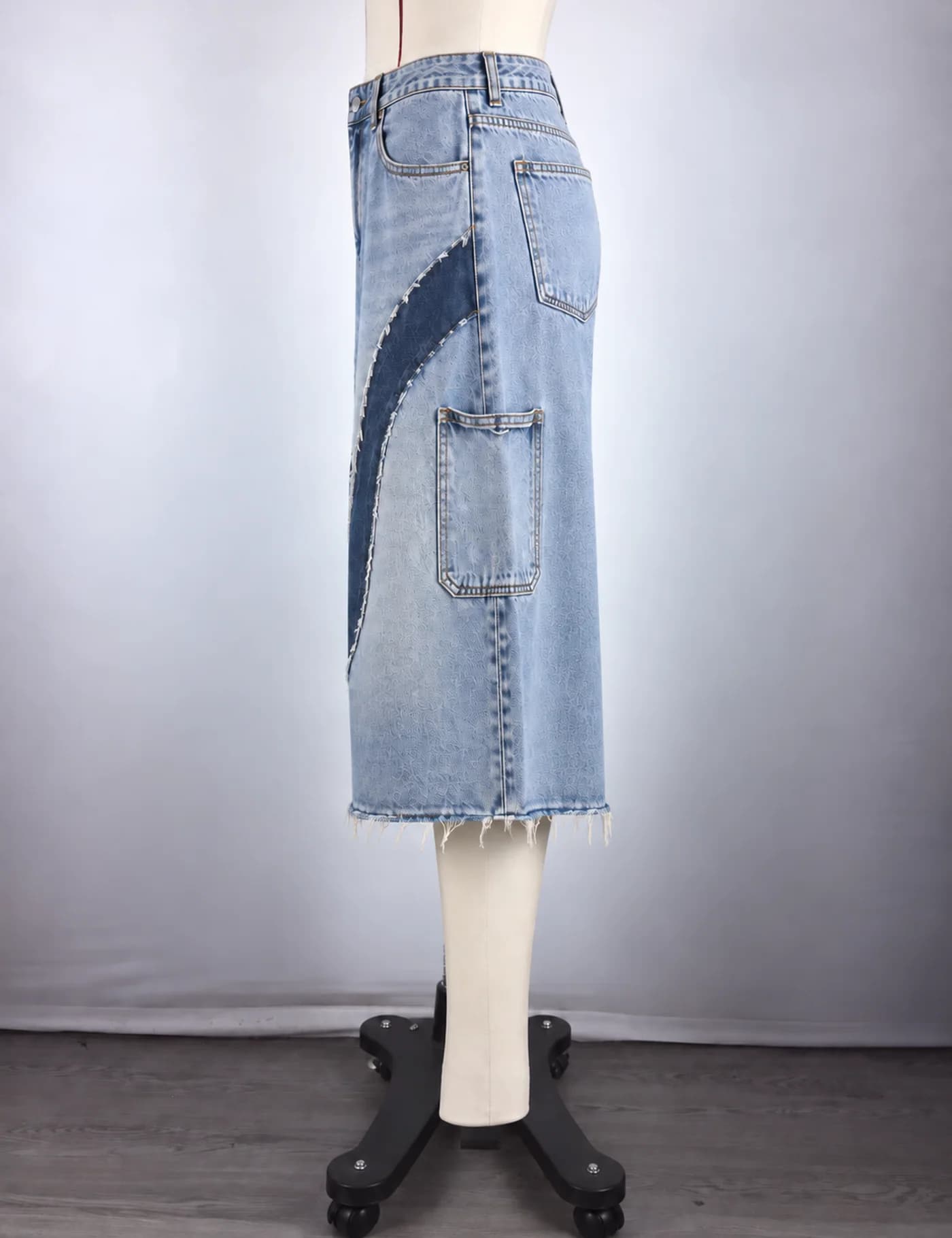 Actual raw-edge appliqué denim jorts sample shown from the side on a mannequin