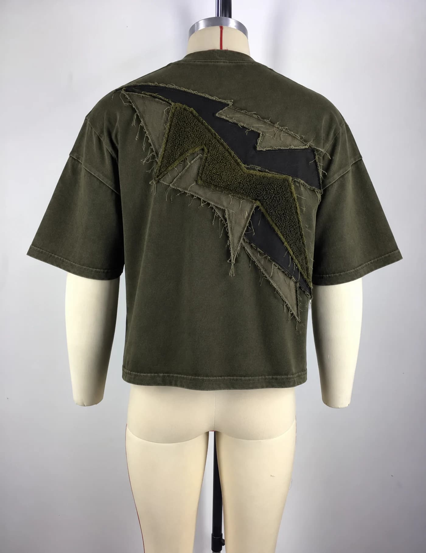 Actual raw-edge appliqué oversized t-shirt sample shown from the back on a mannequin
