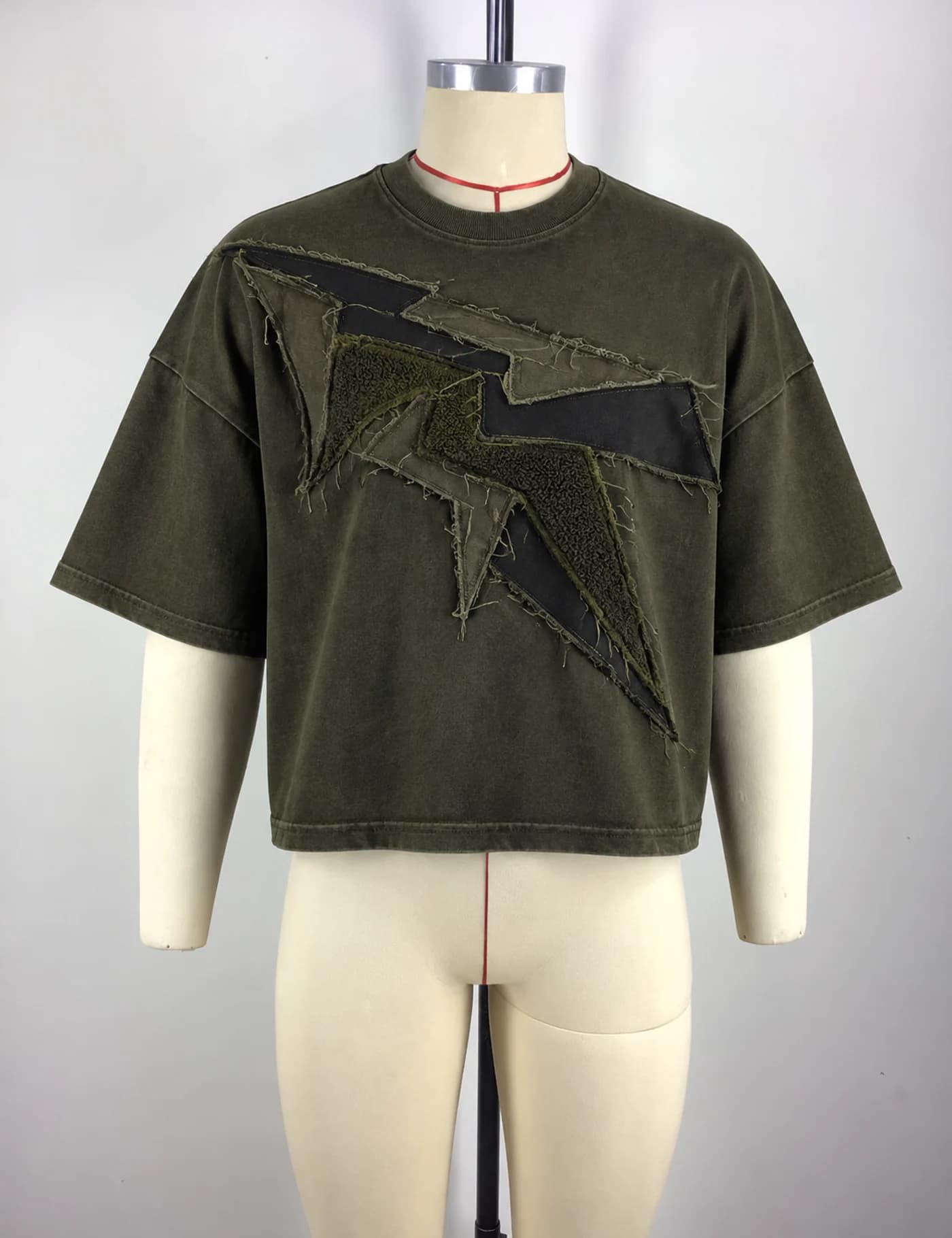 Actual raw-edge appliqué oversized t-shirt sample shown from the front on a mannequin