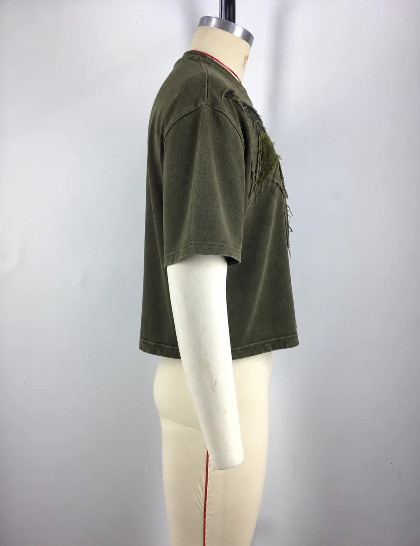 Actual raw-edge appliqué oversized t-shirt sample shown from the side on a mannequin