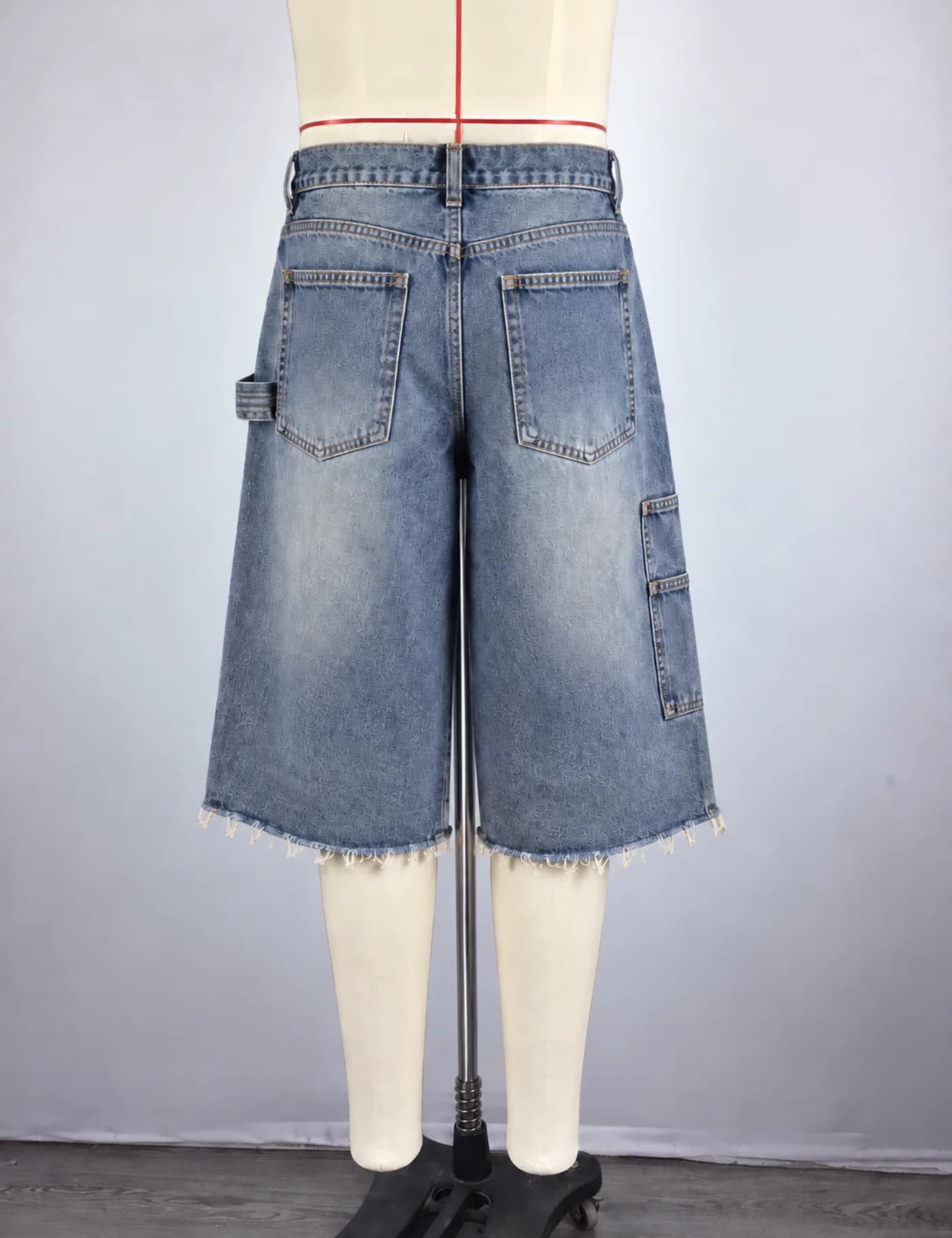 Actual raw-hem carpenter denim jorts sample shown from the back on a mannequin