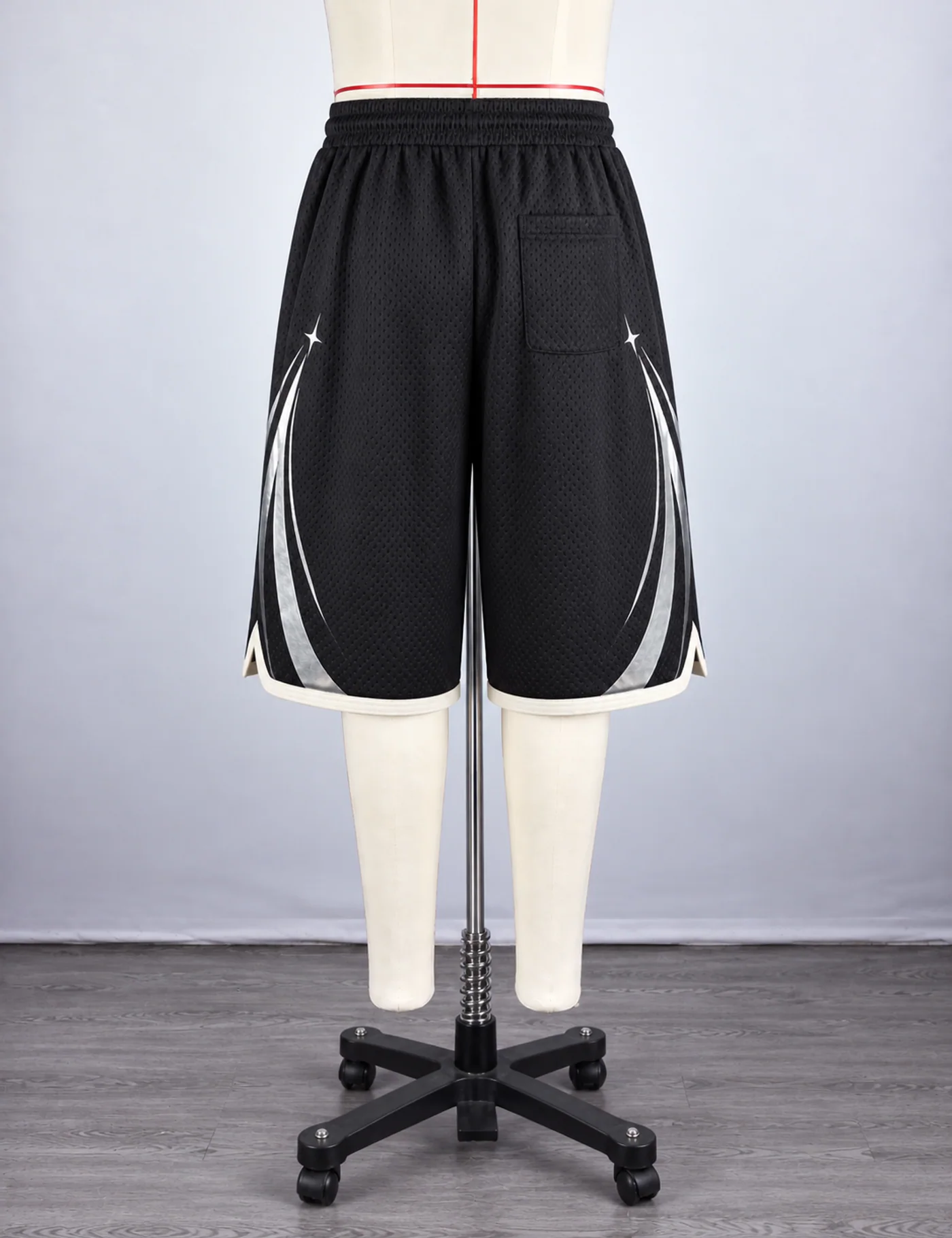 Actual reflective arc mesh basketball shorts sample shown from the back on a mannequin