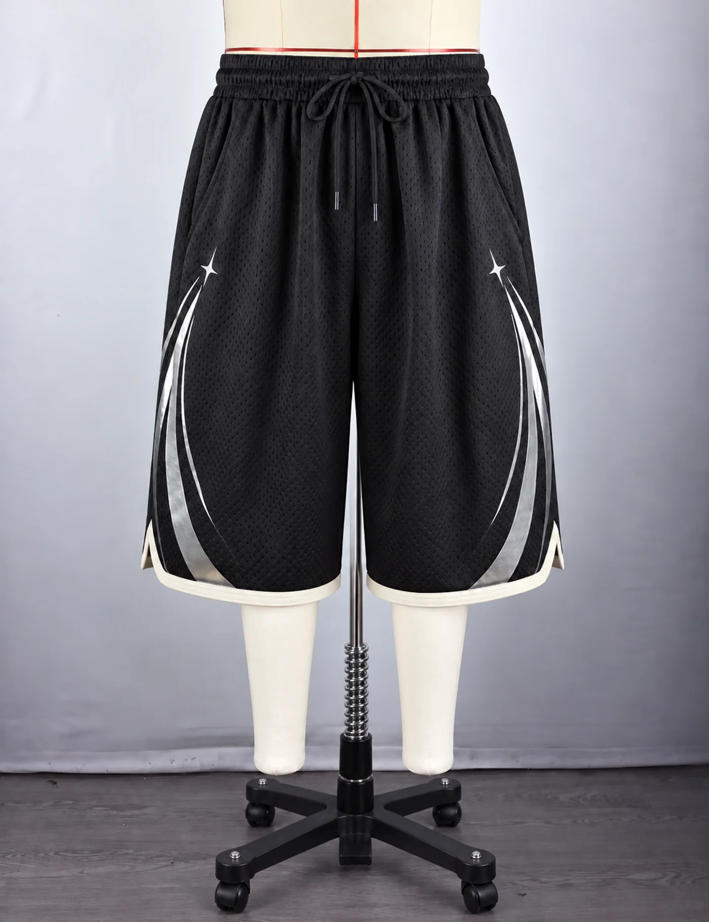 Actual reflective arc mesh basketball shorts sample shown from the front on a mannequin