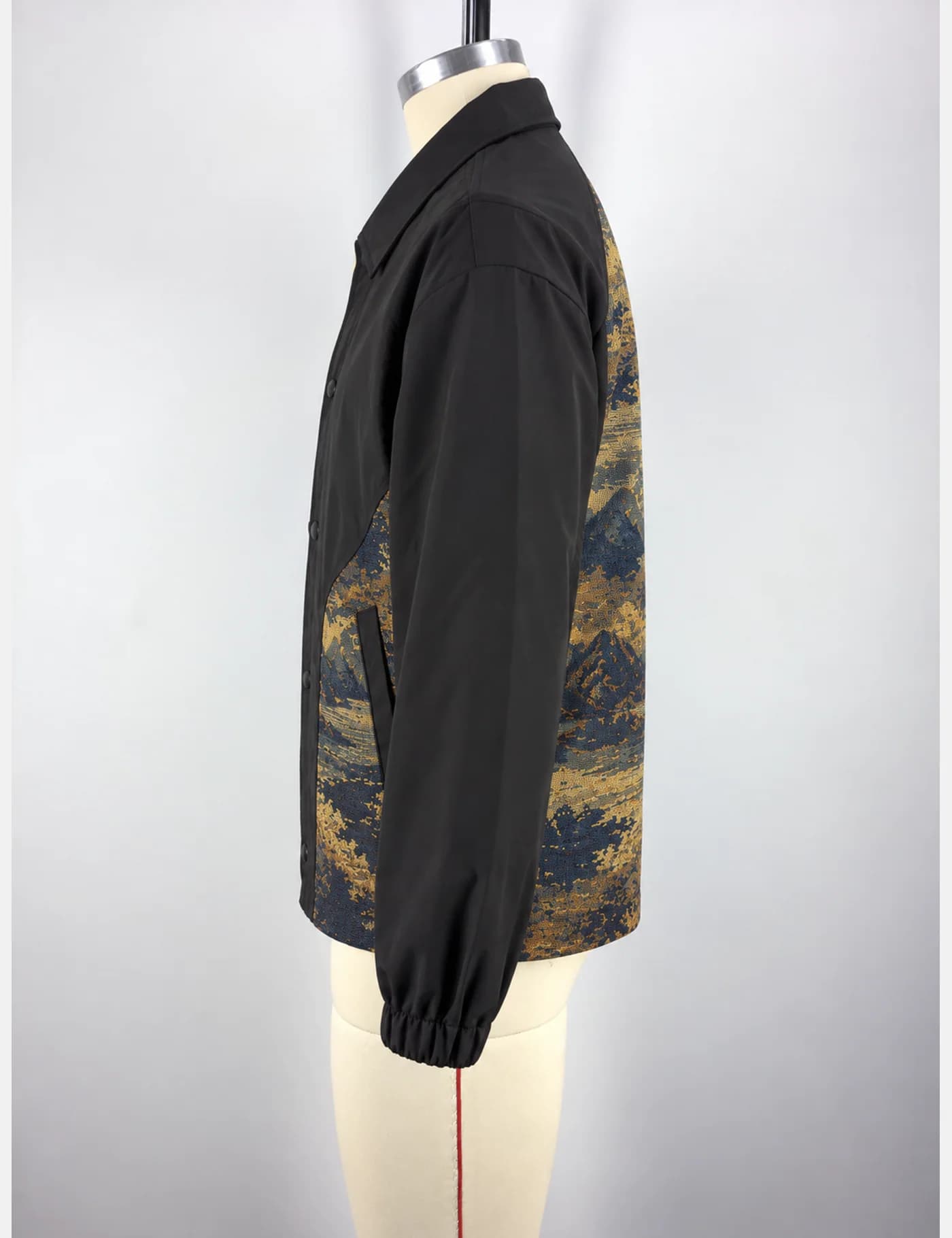 Actual tapestry landscape-panel coach jacket sample shown from the side on a mannequin