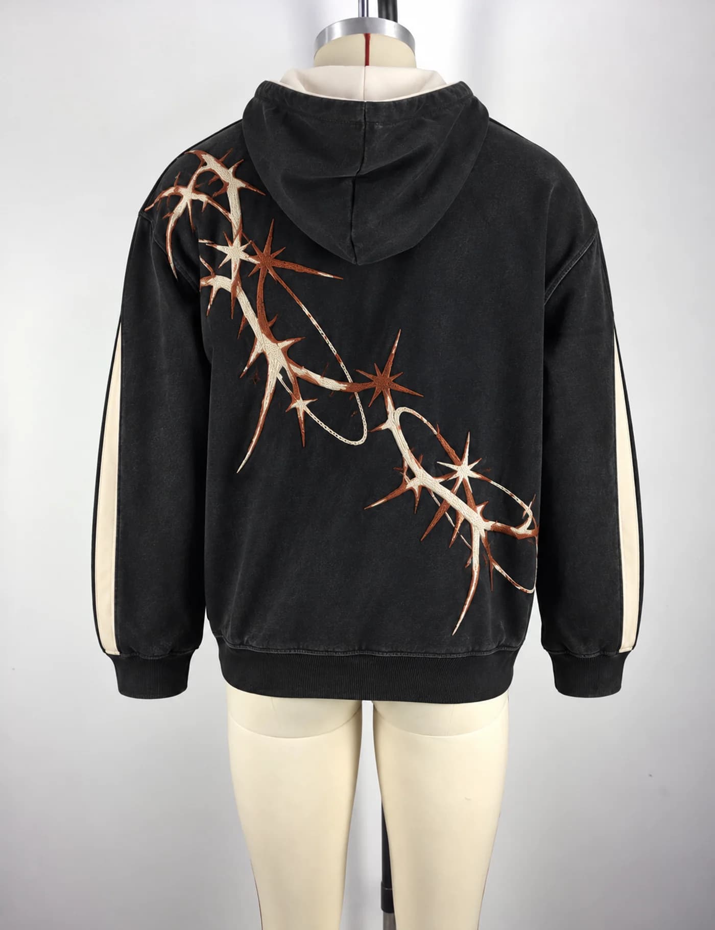 Actual thorn embroidered oversized hoodie sample shown from the back on a mannequin