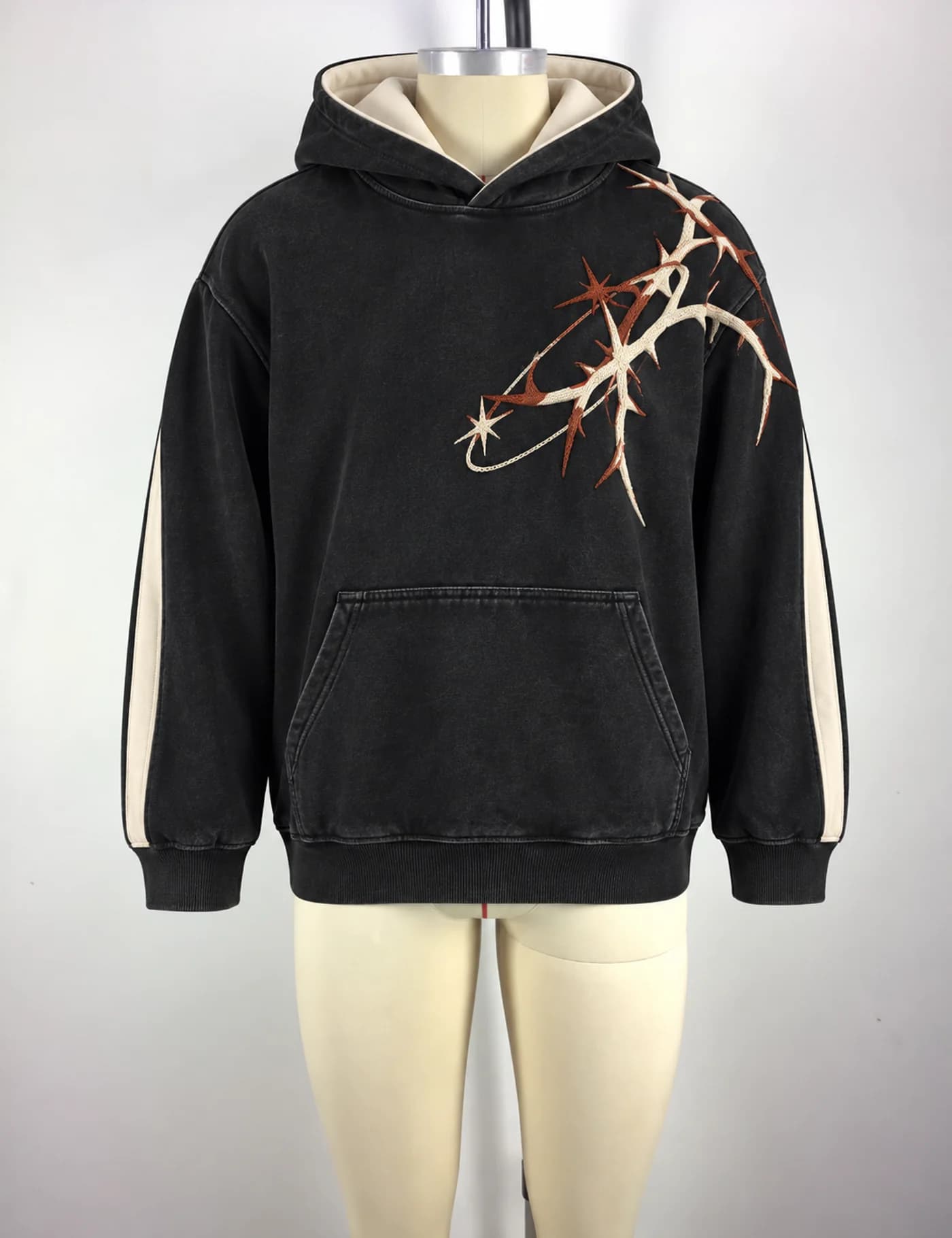 Actual thorn embroidered oversized hoodie sample shown from the front on a mannequin