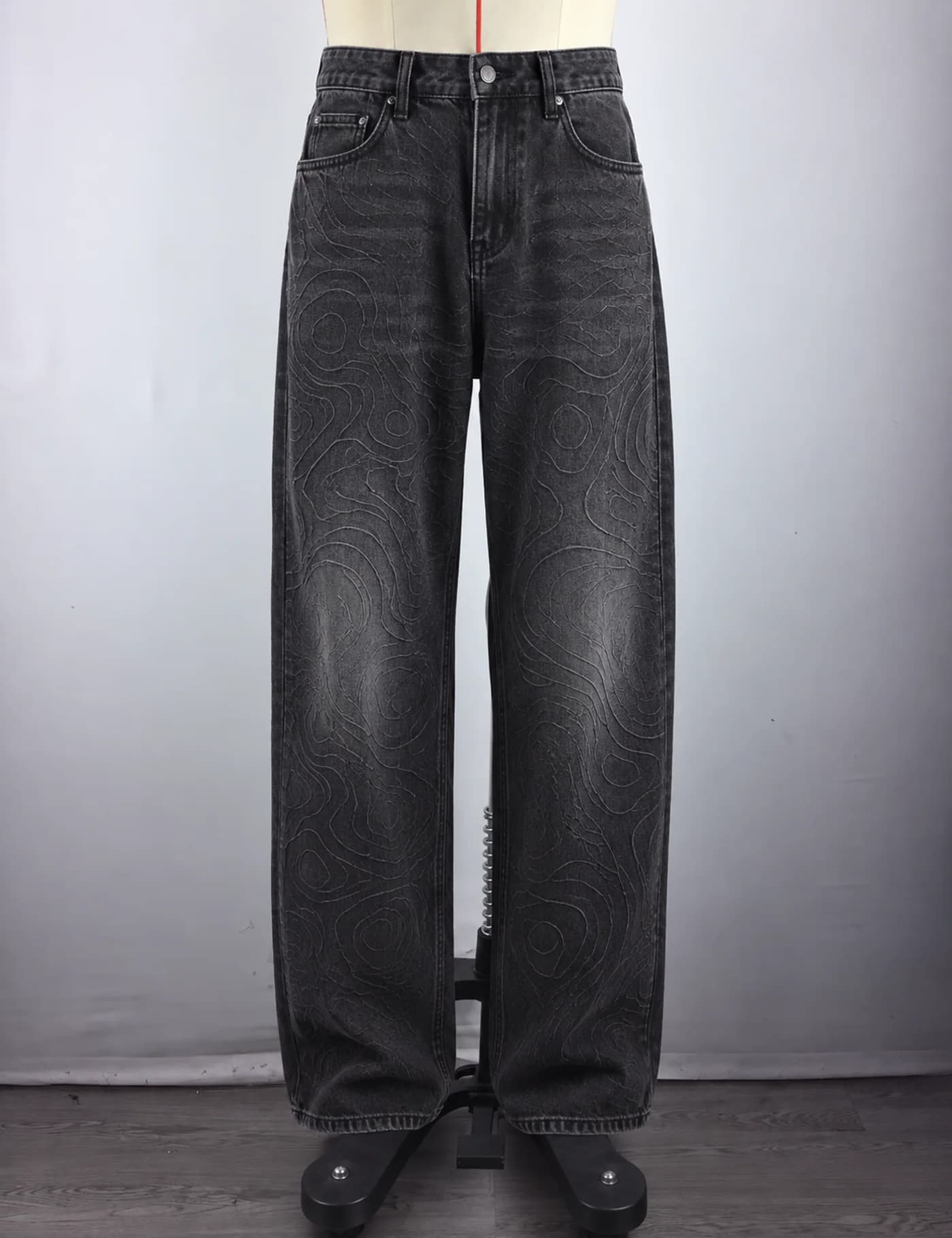 Actual topographic pattern wide-leg jeans sample shown from the front on a mannequin