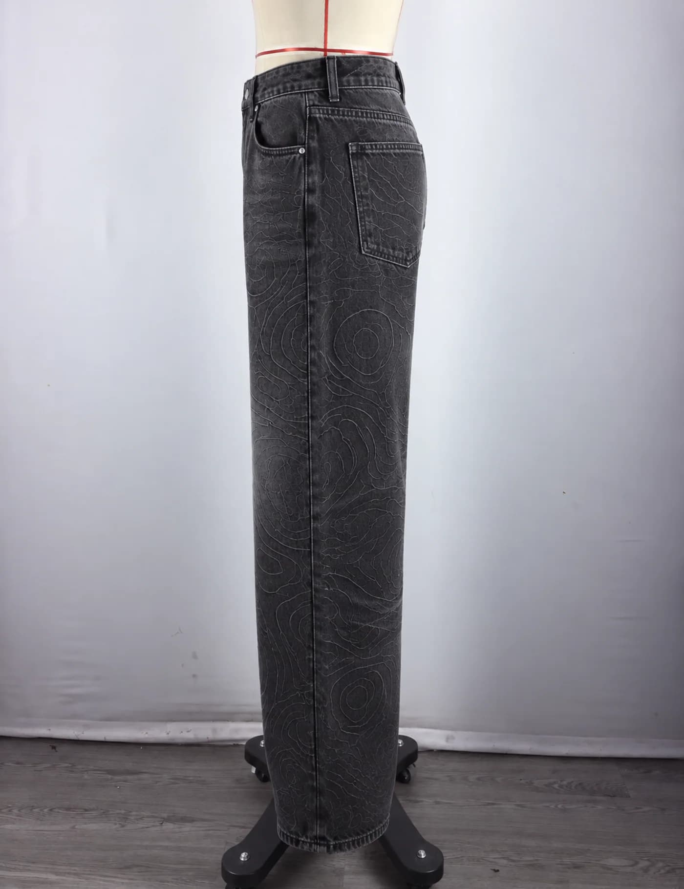 Actual topographic pattern wide-leg jeans sample shown from the side on a mannequin