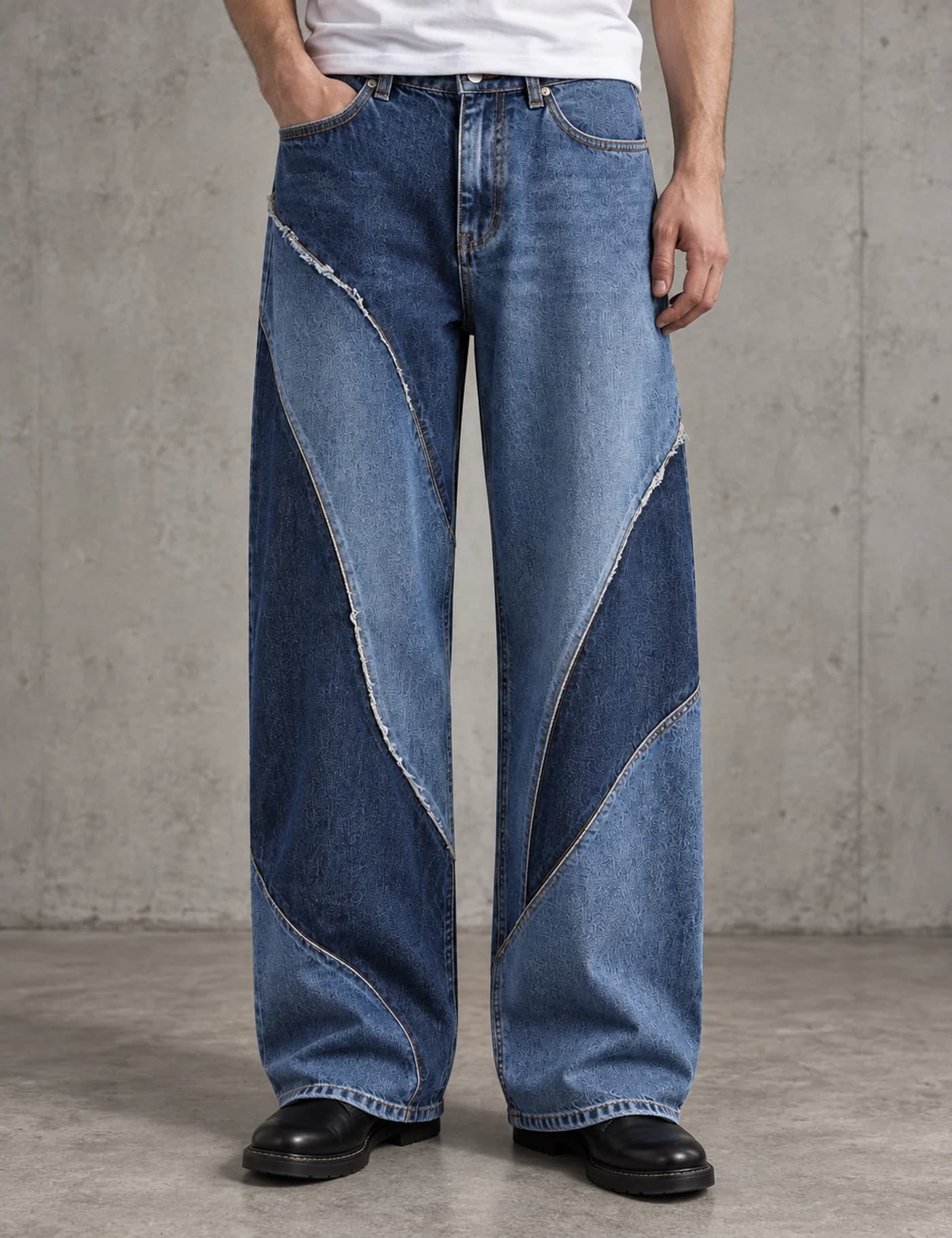 Male model wearing two-tone blue wide-leg jeans with sweeping curved raw-edge panels
