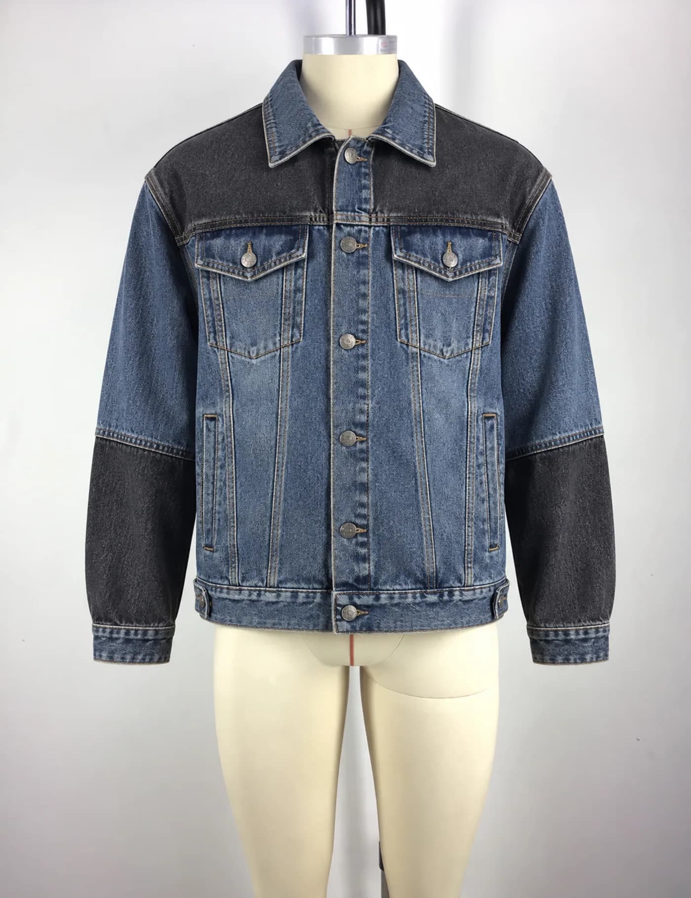 Actual two-tone denim trucker jacket sample shown from the front on a mannequin