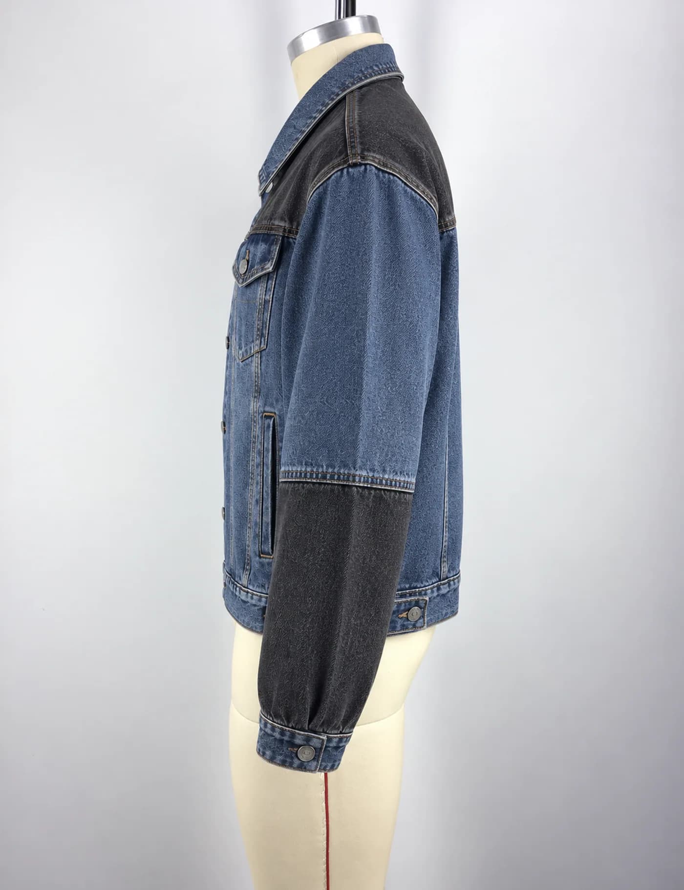 Actual two-tone denim trucker jacket sample shown from the side on a mannequin