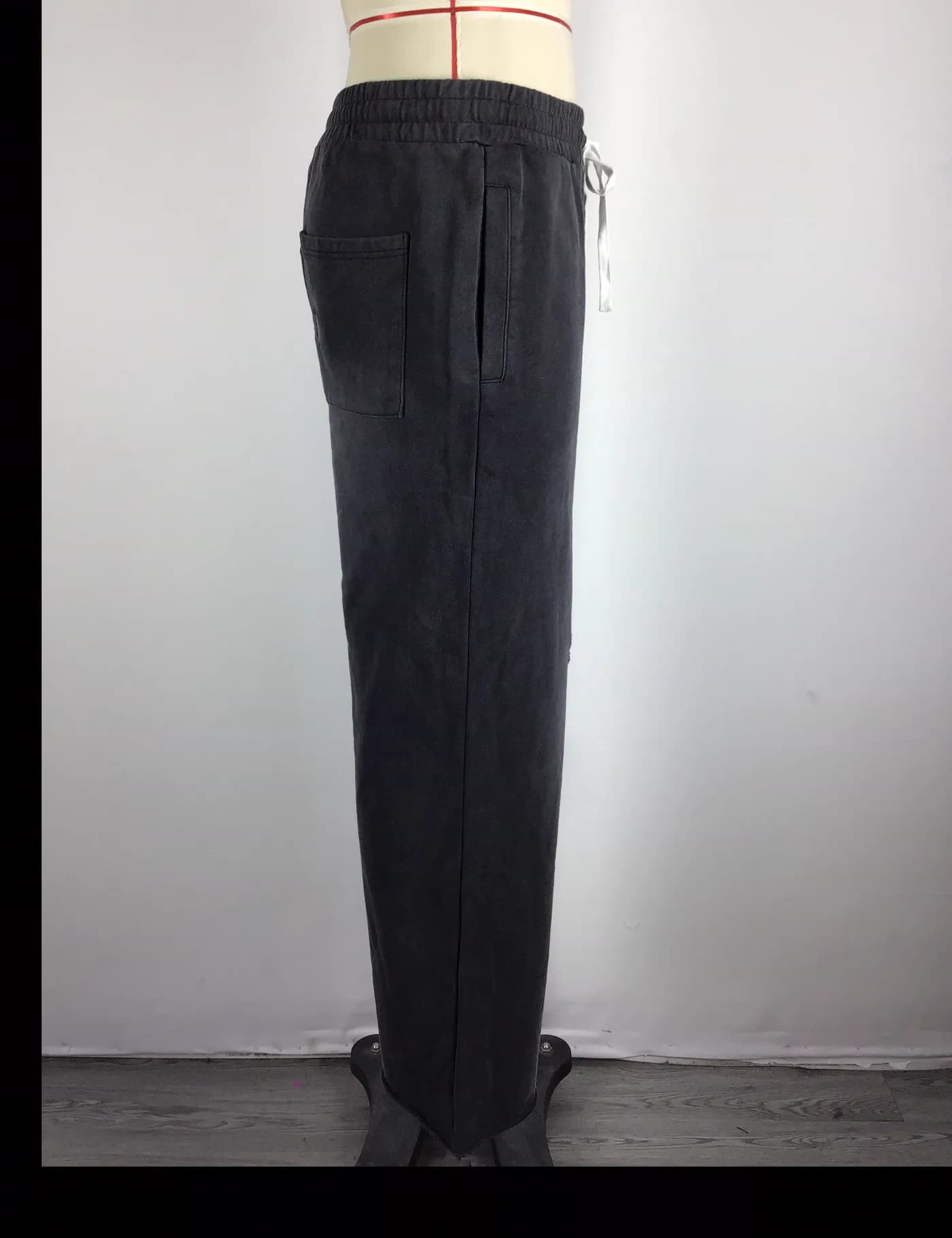 Actual vintage washed straight-leg sweatpants sample shown from the side on a mannequin