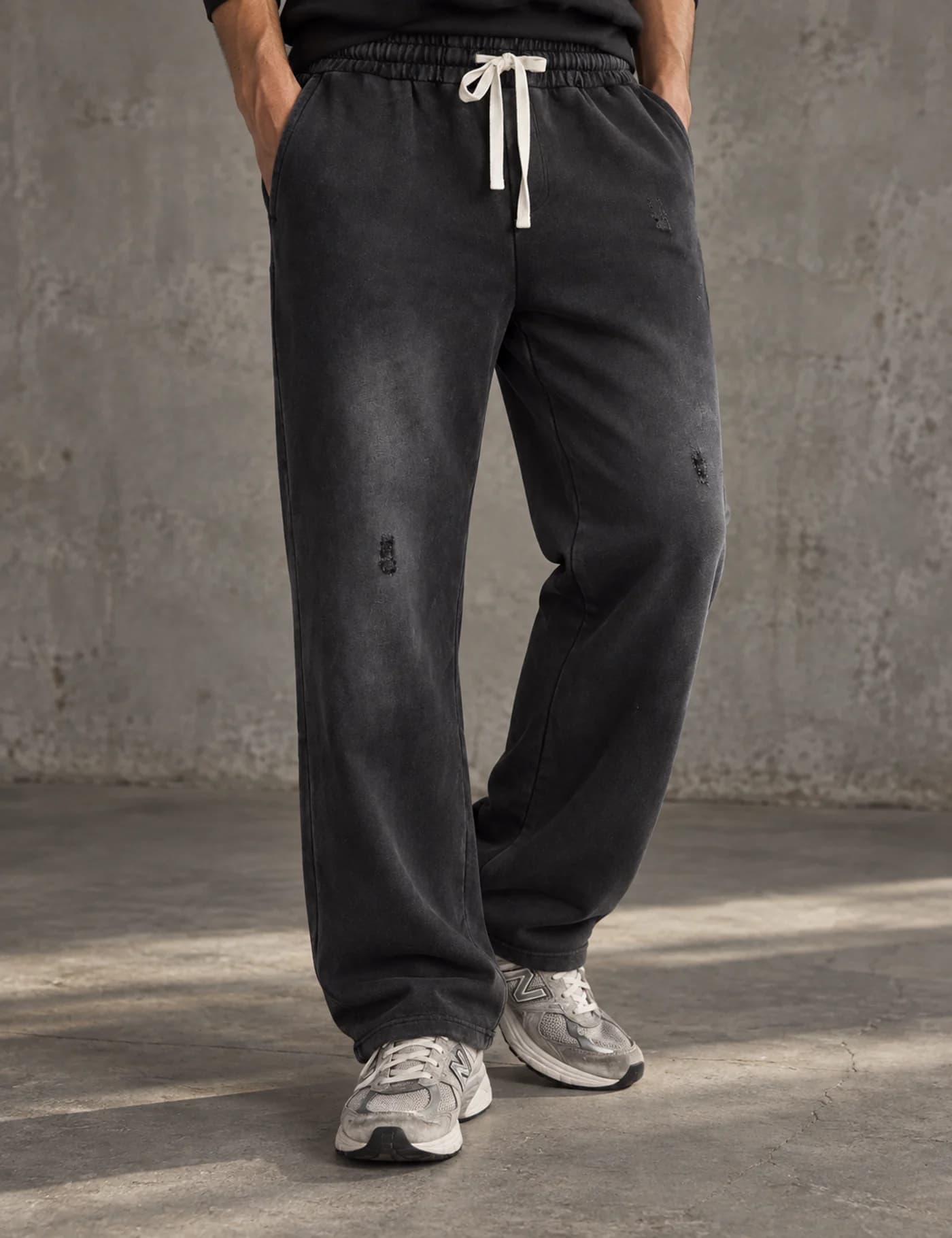 Male model wearing charcoal vintage-washed straight-leg sweatpants with a white drawcord