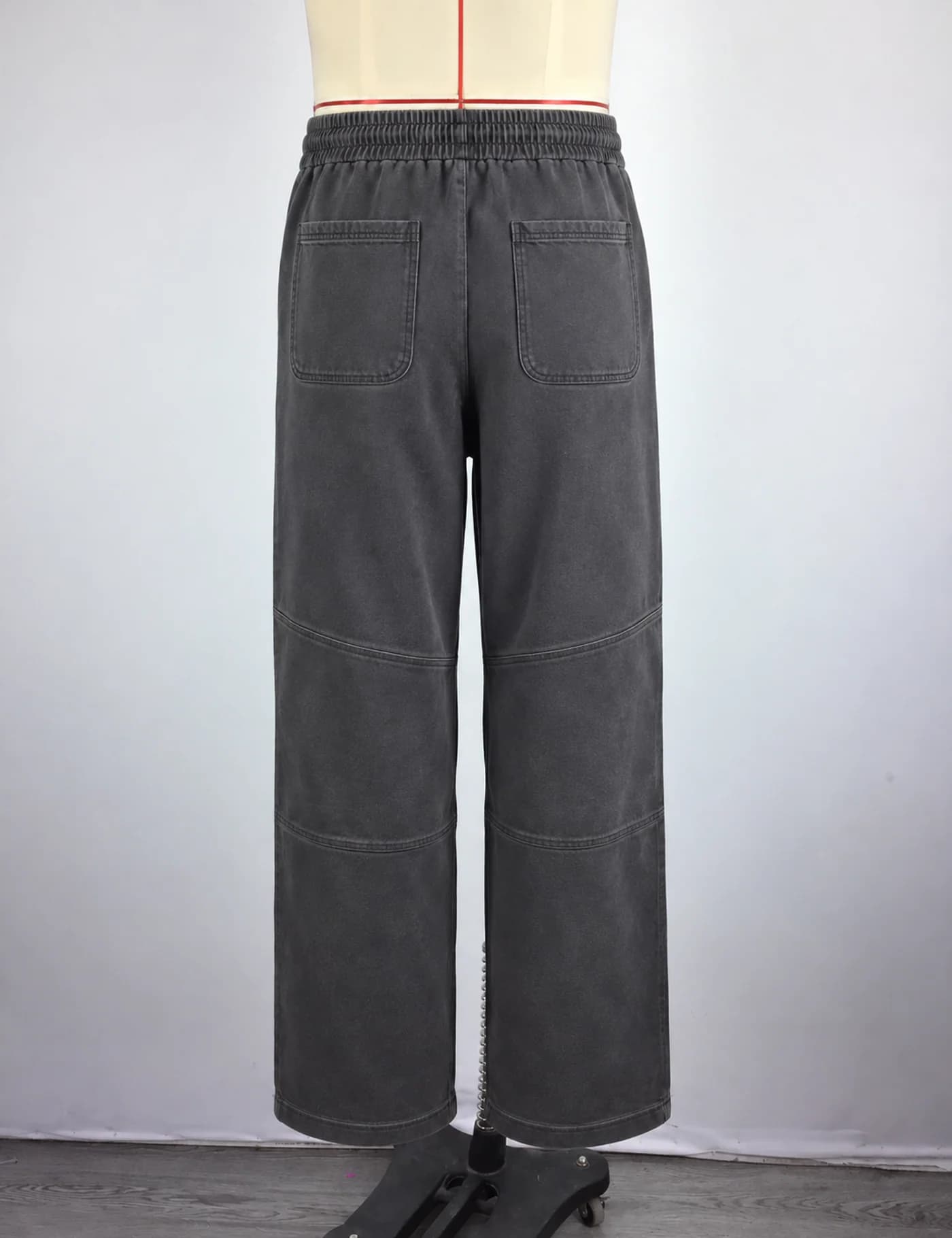 Actual washed articulated-knee wide-leg sweatpants sample shown from the back on a mannequin