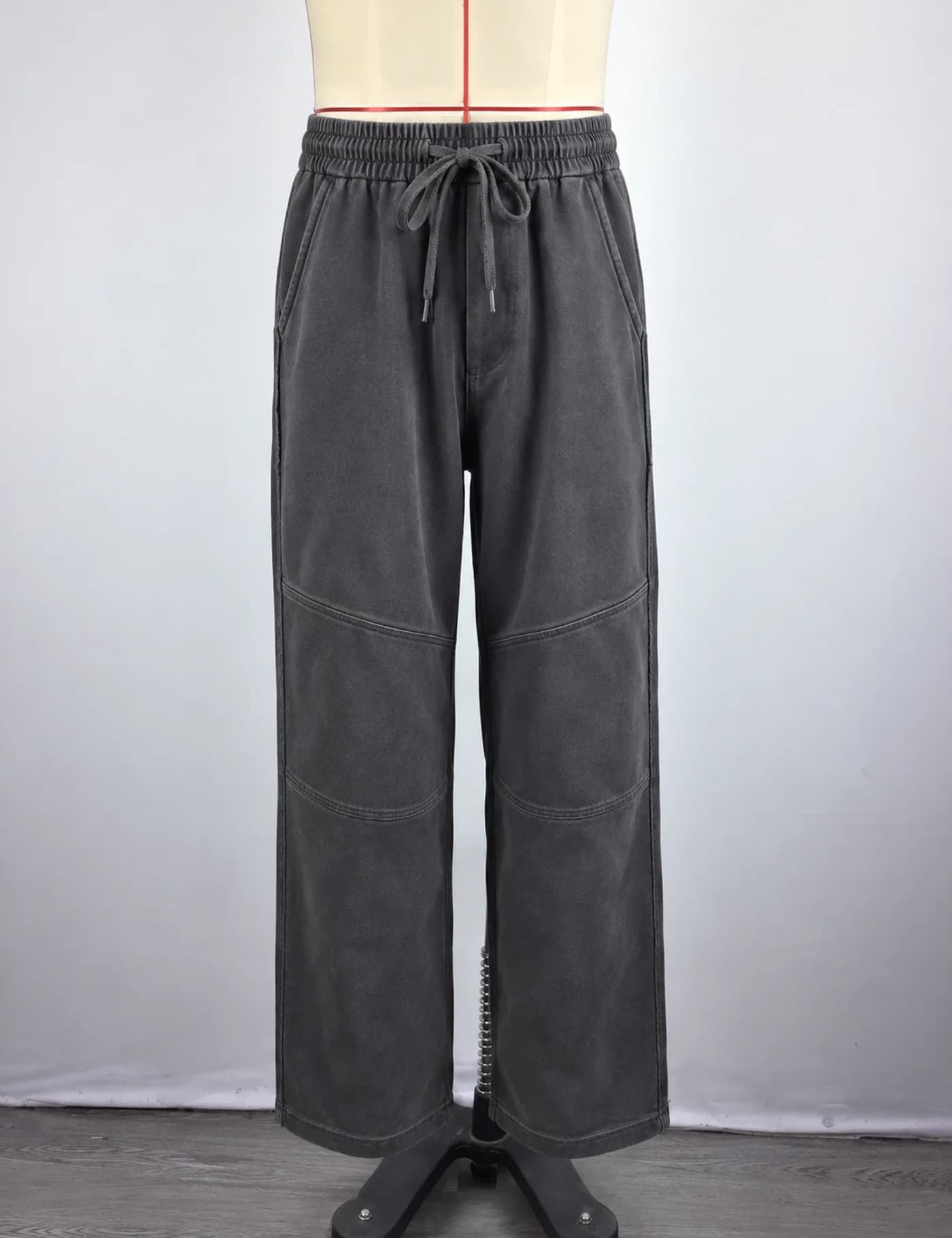 Actual washed articulated-knee wide-leg sweatpants sample shown from the front on a mannequin