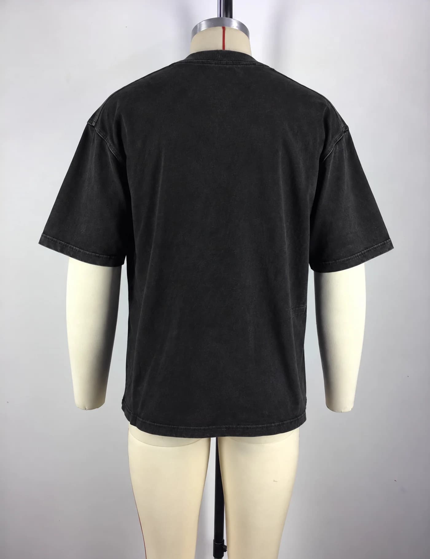 Actual washed asymmetric-seam oversized t-shirt sample shown from the back on a mannequin