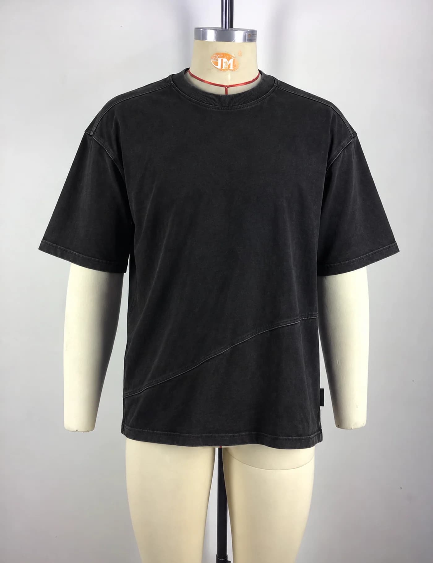 Actual washed asymmetric-seam oversized t-shirt sample shown from the front on a mannequin