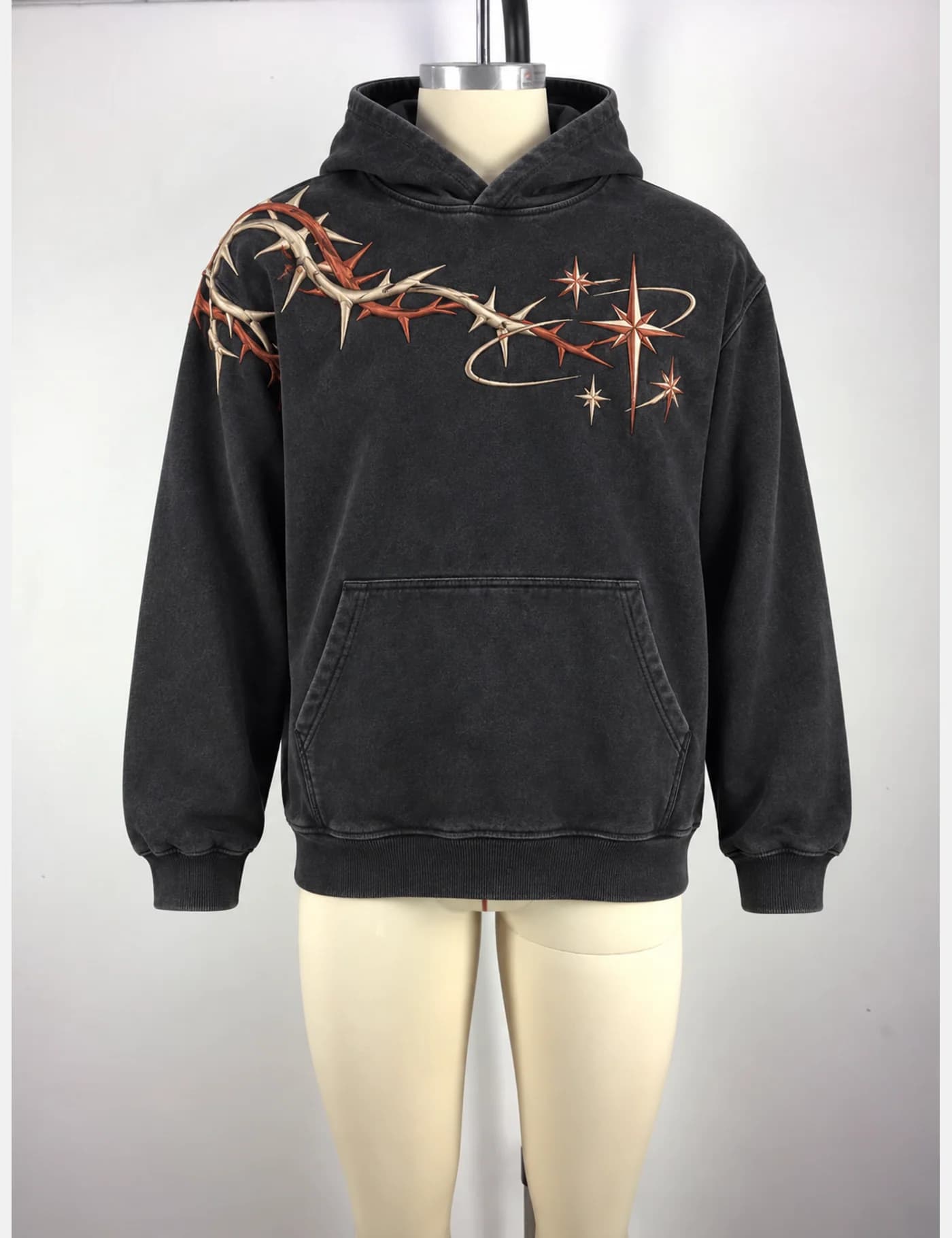 Actual washed barbed-vine embroidered hoodie sample shown from the front on a mannequin