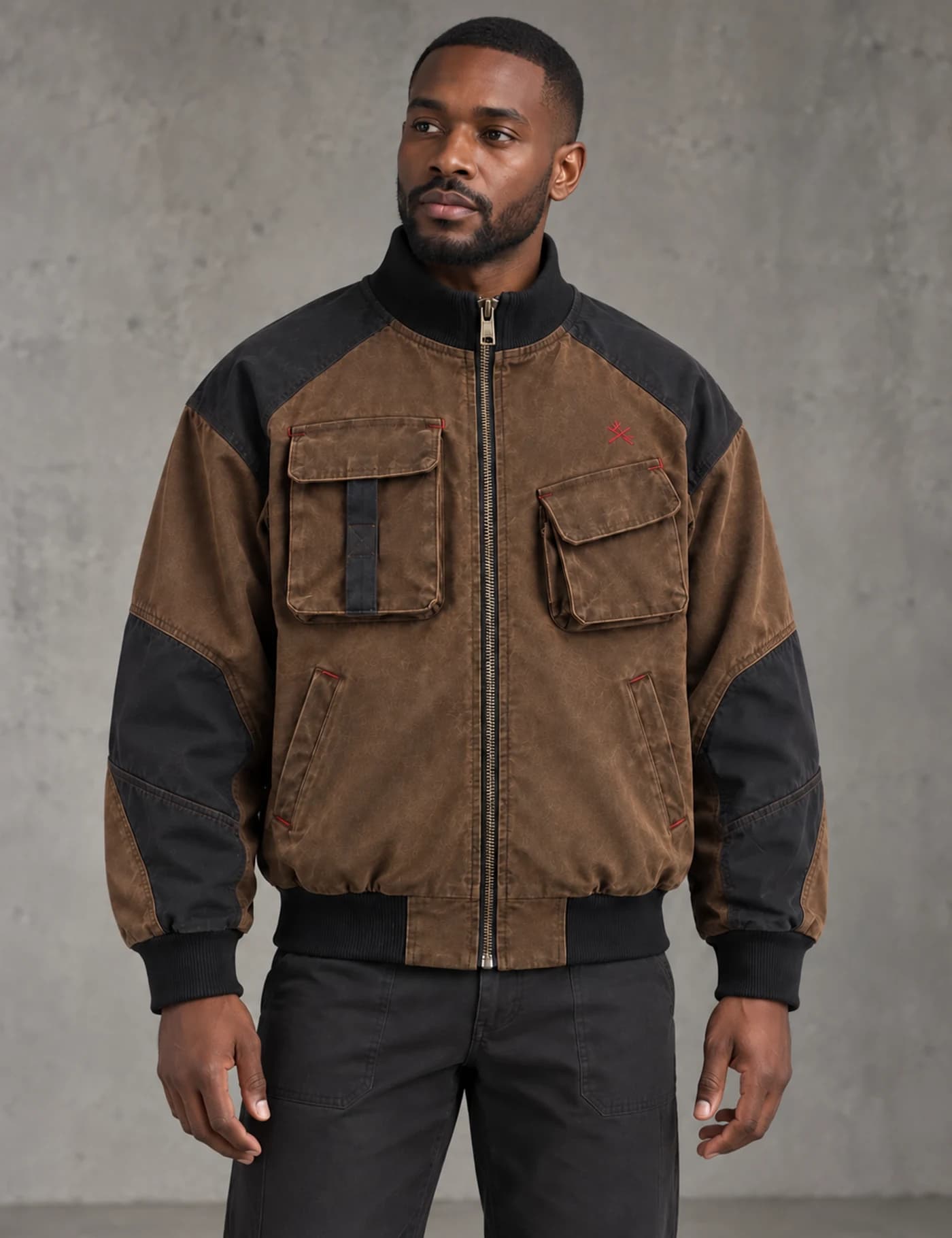 Black male model wearing a washed brown and black color-block utility bomber jacket