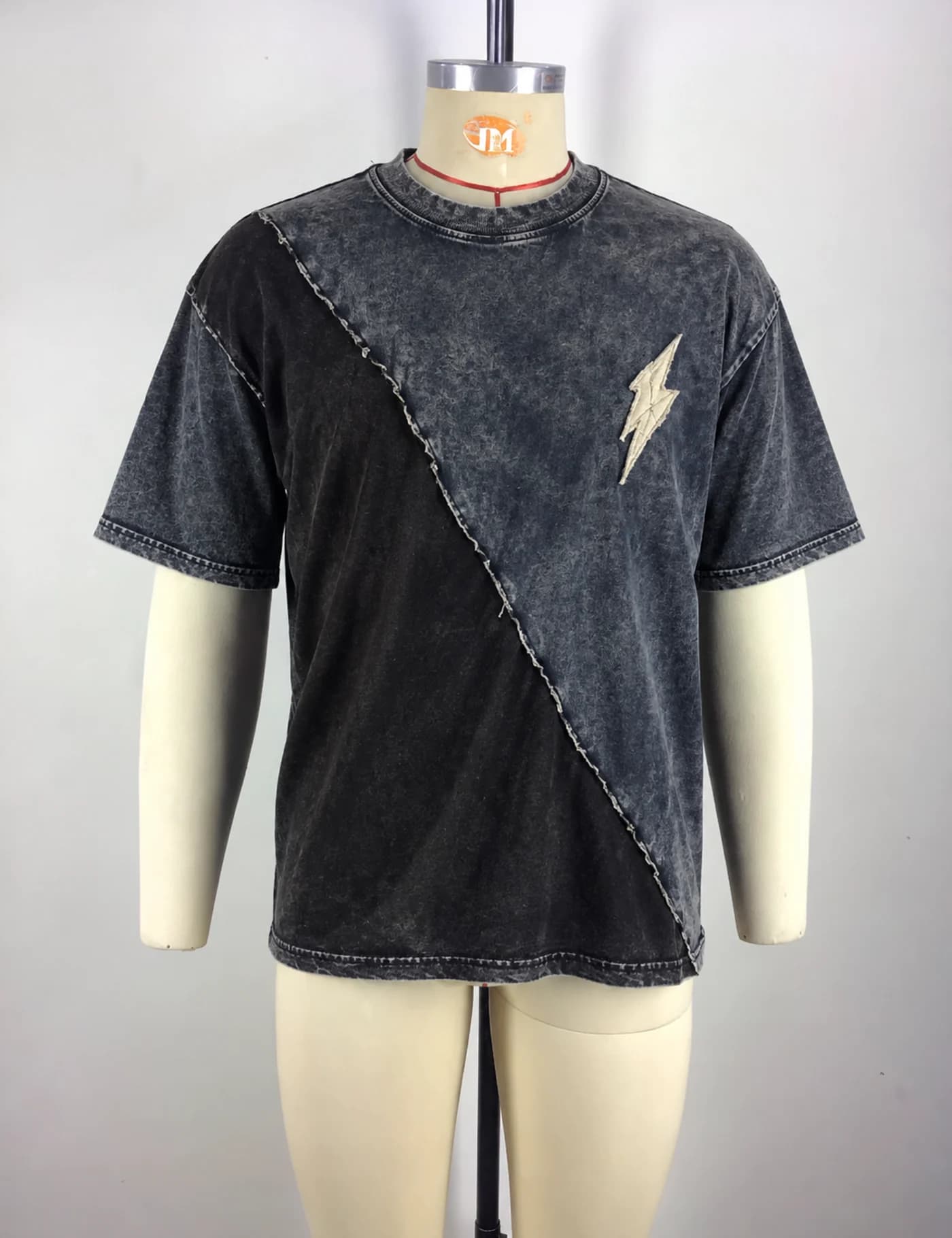 Actual washed contrast-panel t-shirt sample shown from the front on a mannequin