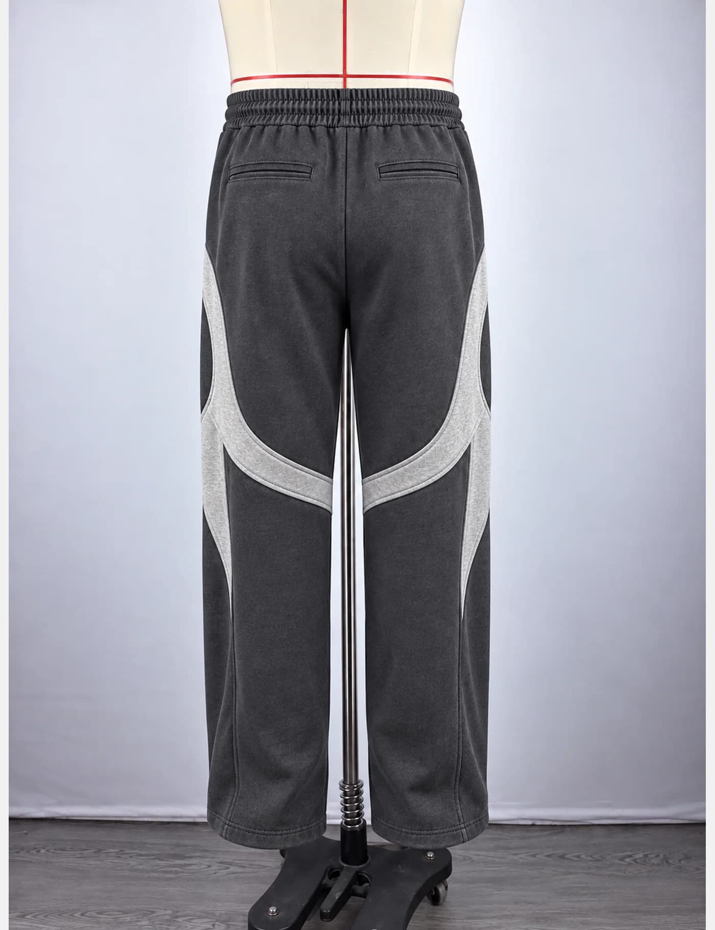 Actual washed curved-panel wide-leg sweatpants sample shown from the back on a mannequin
