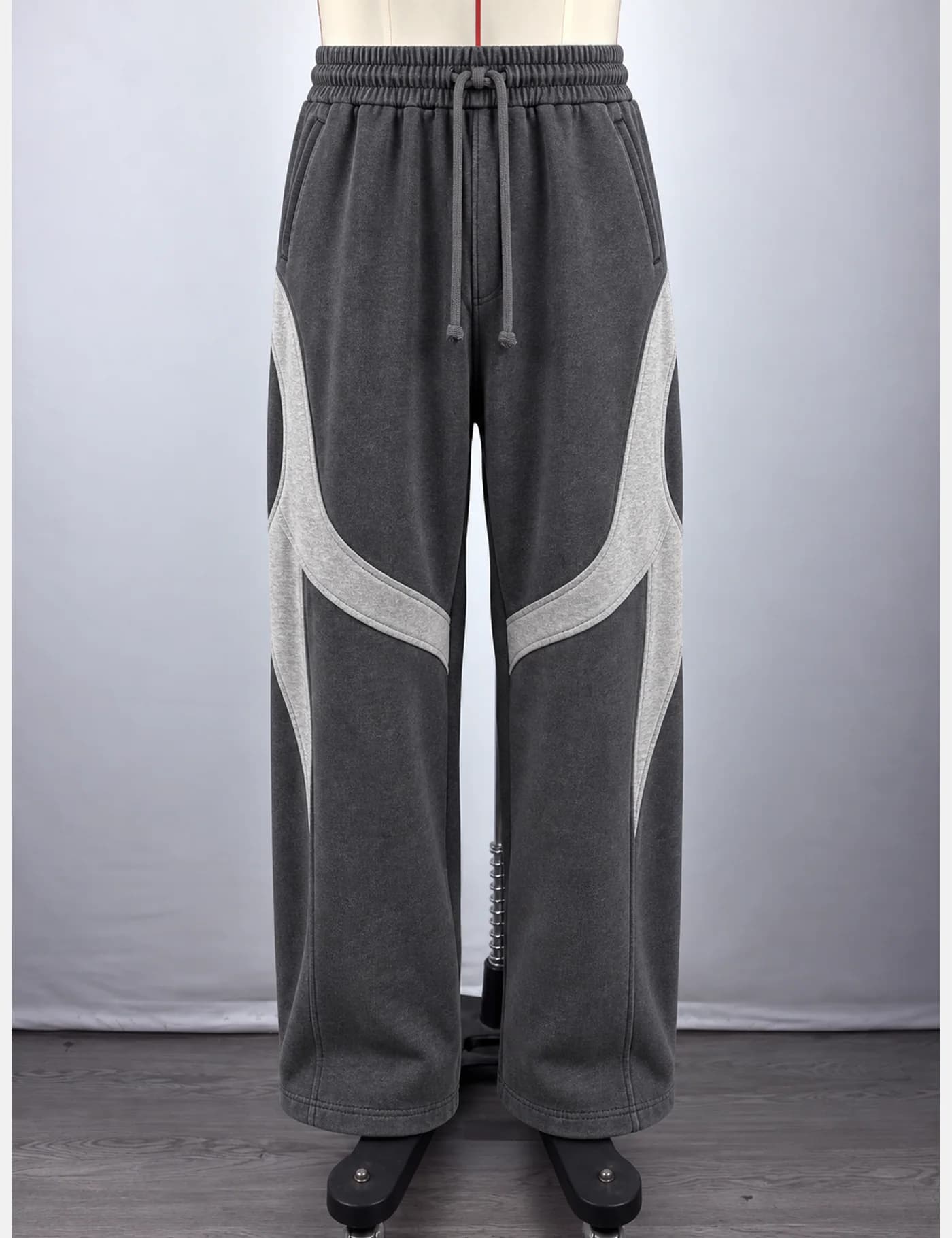 Actual washed curved-panel wide-leg sweatpants sample shown from the front on a mannequin