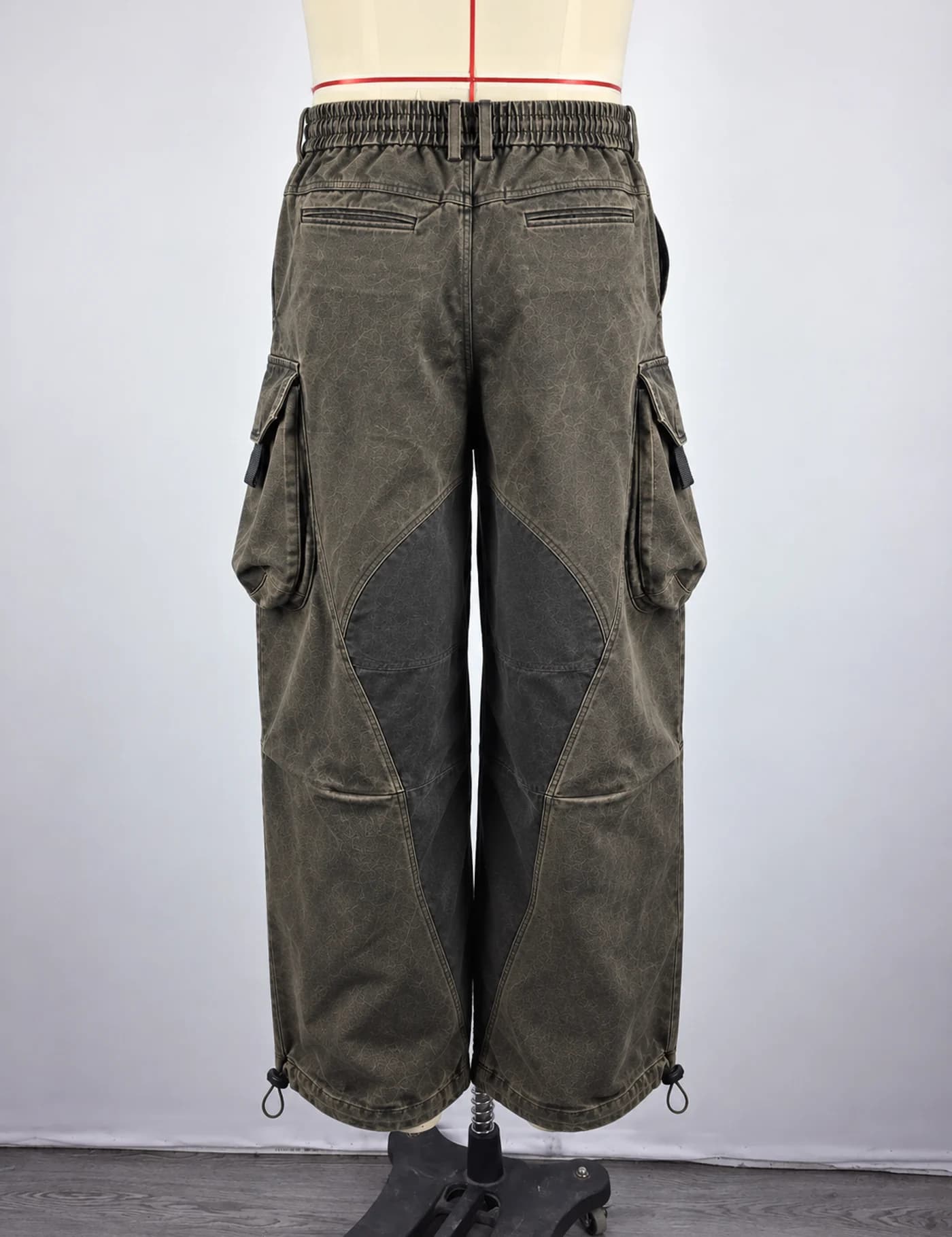 Actual washed multi-pocket cargo pants sample shown from the back on a mannequin