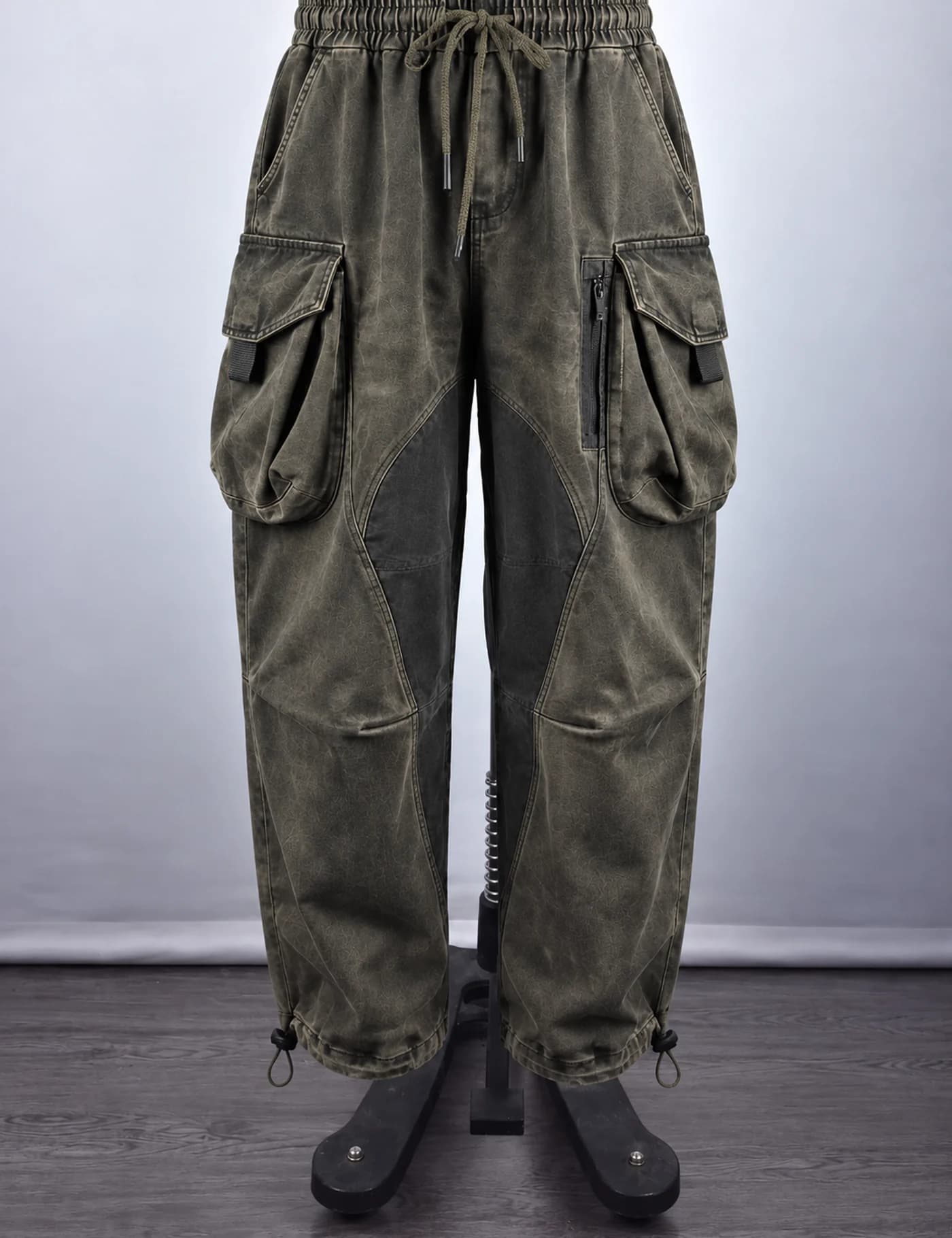 Actual washed multi-pocket cargo pants sample shown from the front on a mannequin
