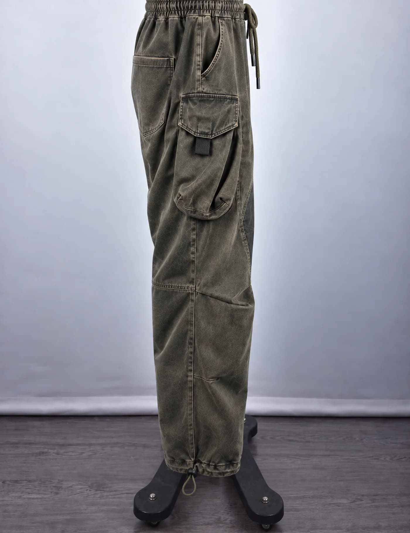 Actual washed multi-pocket cargo pants sample shown from the side on a mannequin