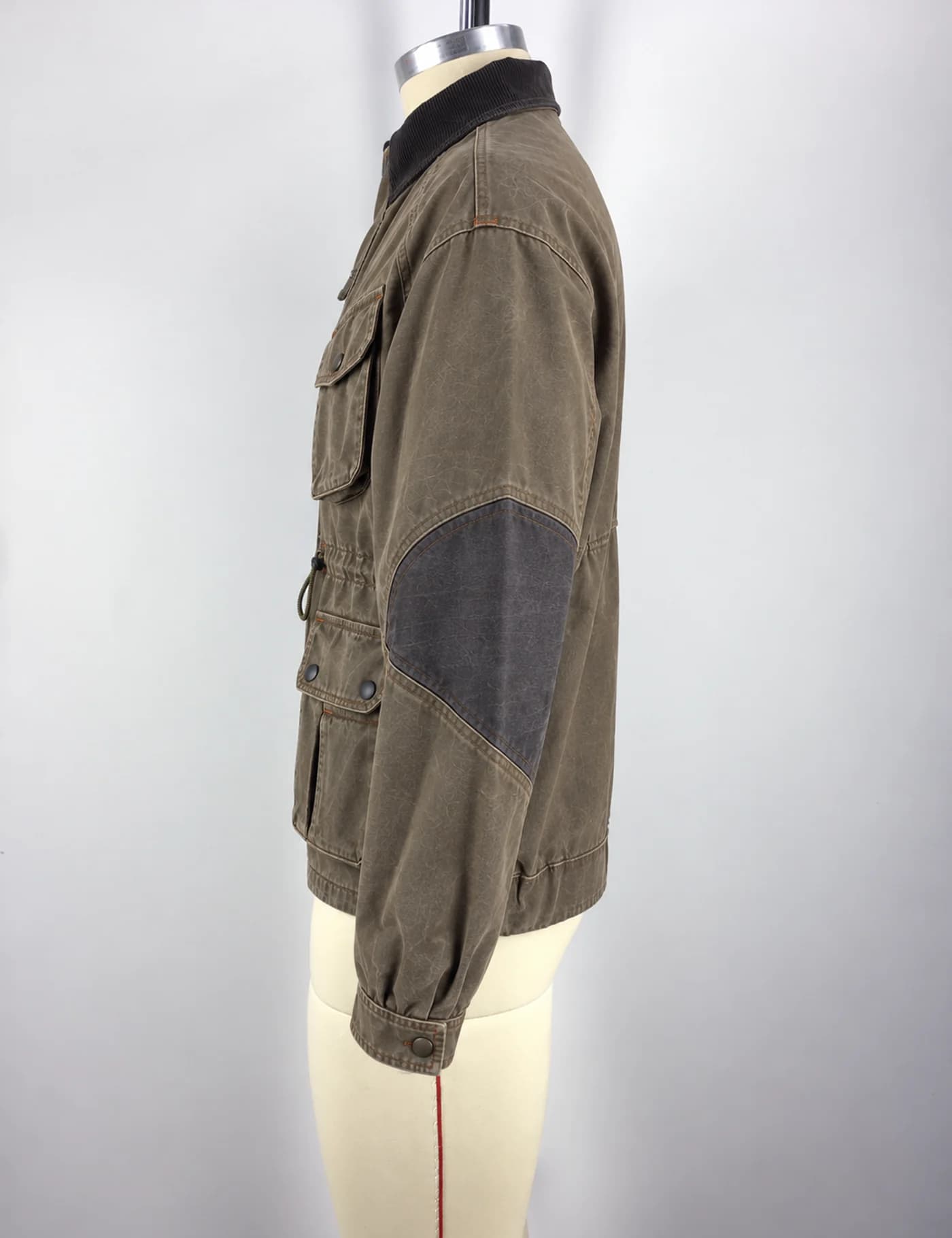 Actual washed multi-pocket field jacket sample shown from the side on a mannequin