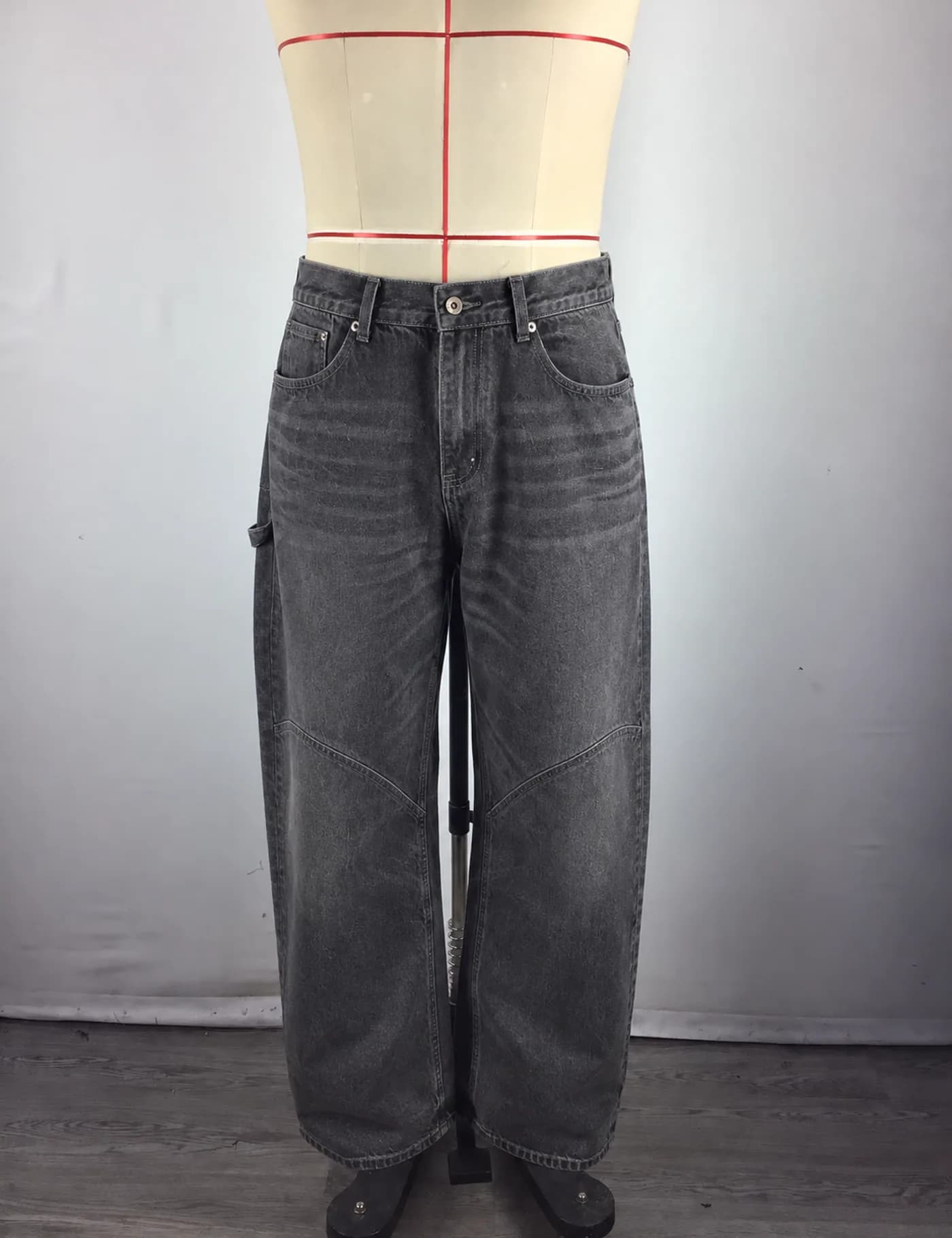Actual washed panel-knee carpenter jeans sample shown from the front on a mannequin