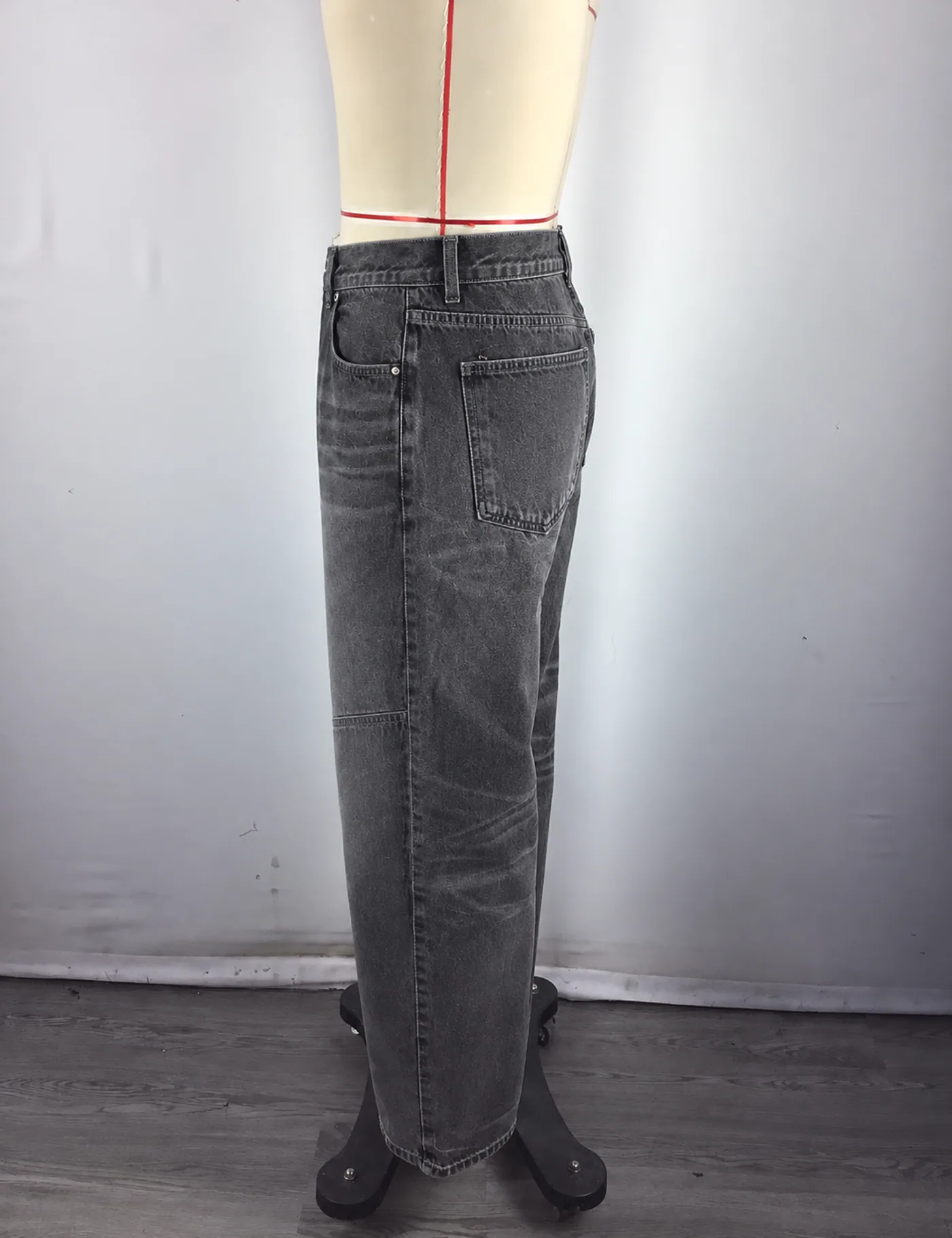 Actual washed panel-knee carpenter jeans sample shown from the side on a mannequin