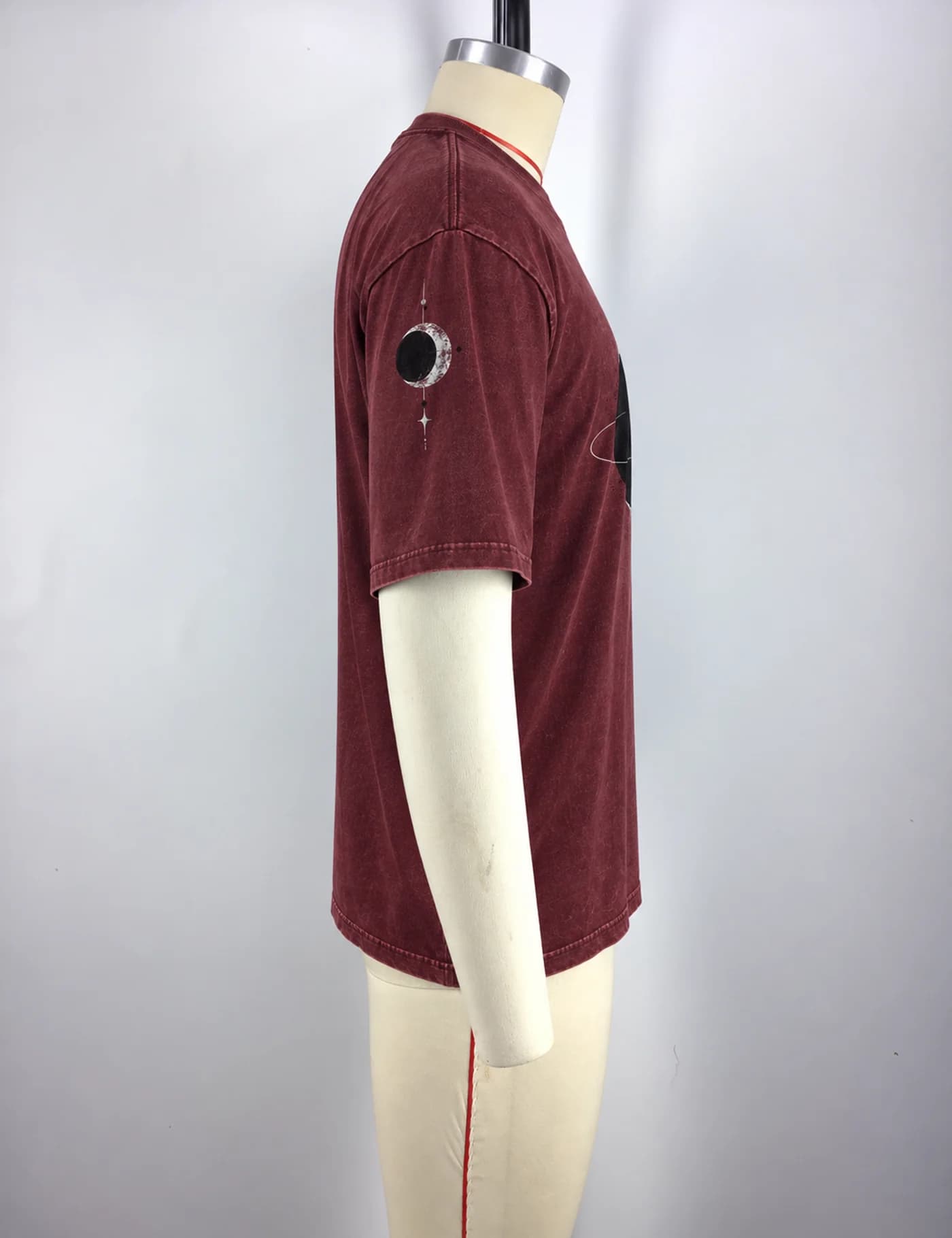 Actual washed planet graphic oversized t-shirt sample shown from the side on a mannequin