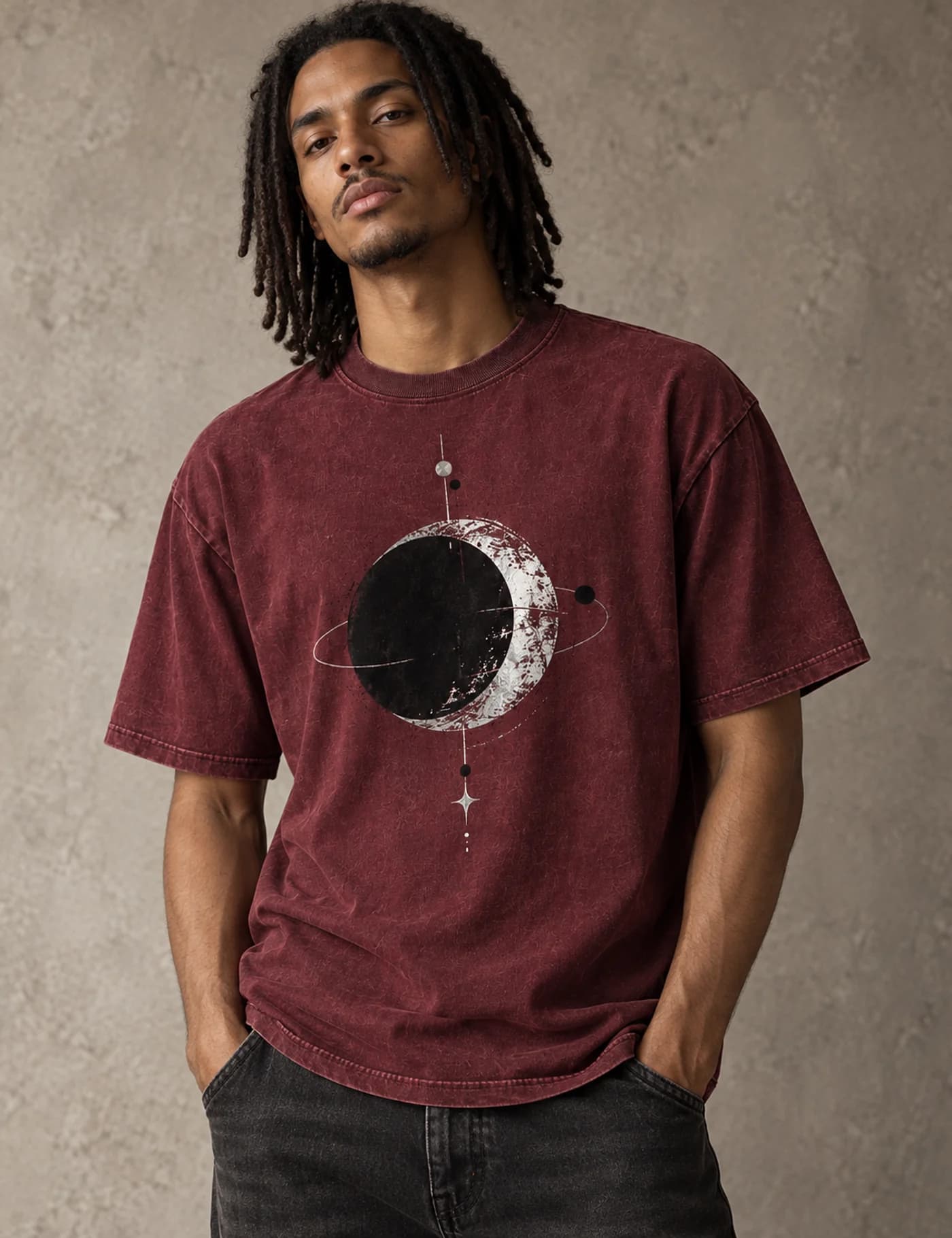 Afro-Latino male model wearing a washed burgundy oversized T-shirt with a circular planet graphic