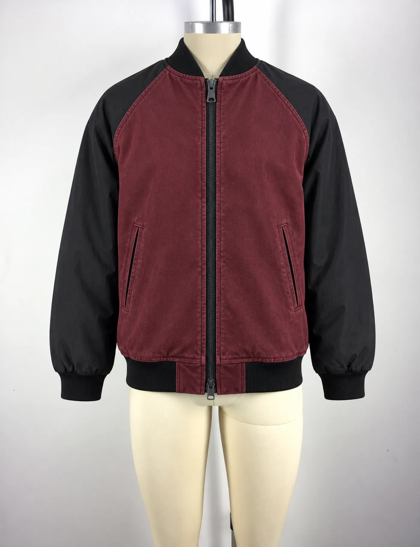 Actual washed two-tone raglan bomber jacket sample shown from the front on a mannequin