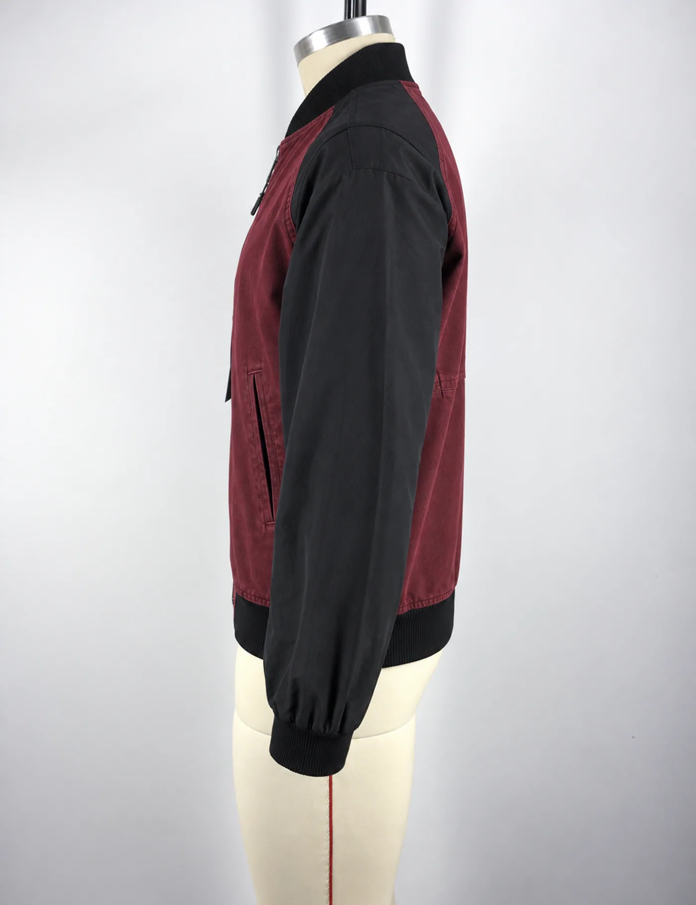 Actual washed two-tone raglan bomber jacket sample shown from the side on a mannequin