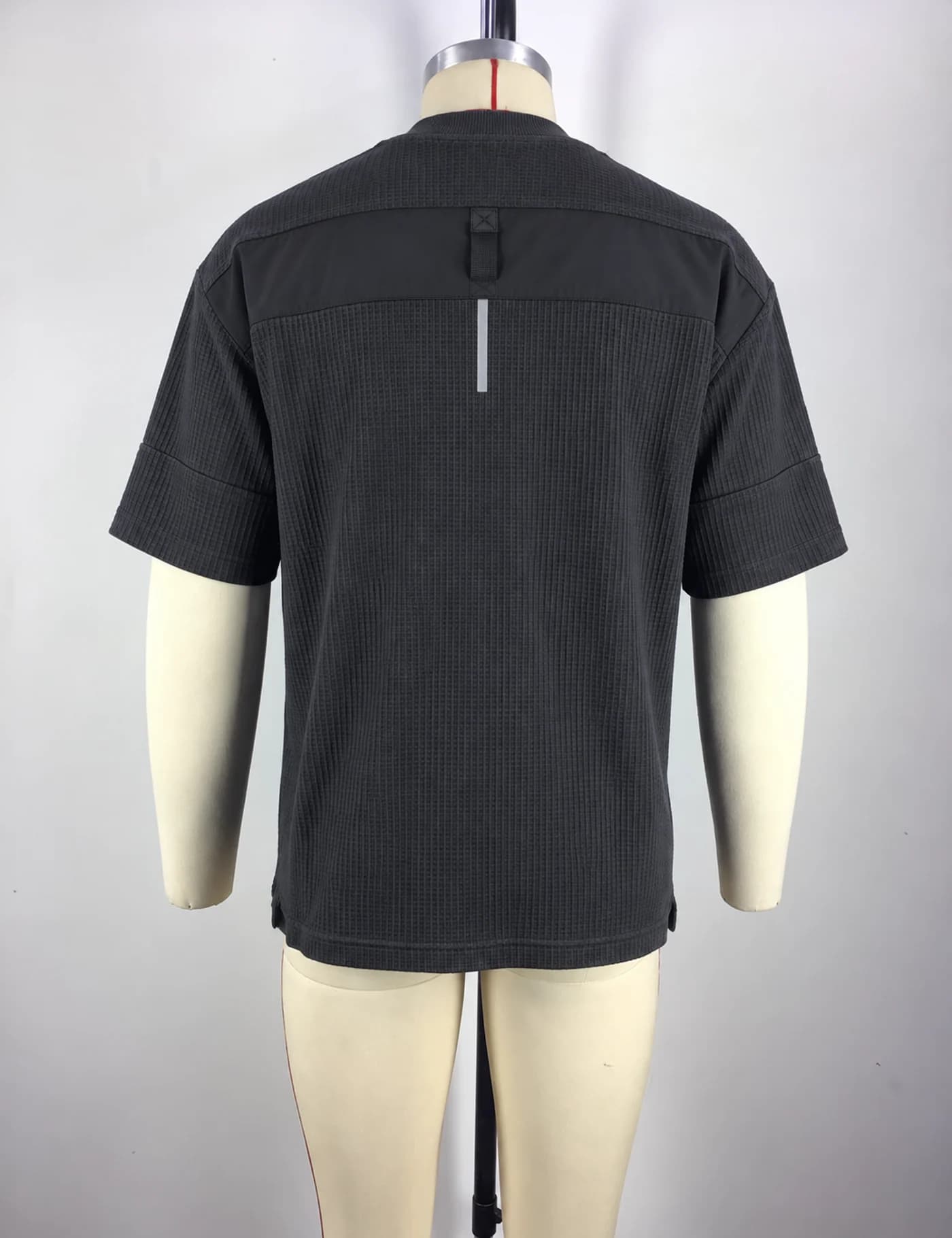 Actual zip-pocket textured t-shirt sample shown from the back on a mannequin