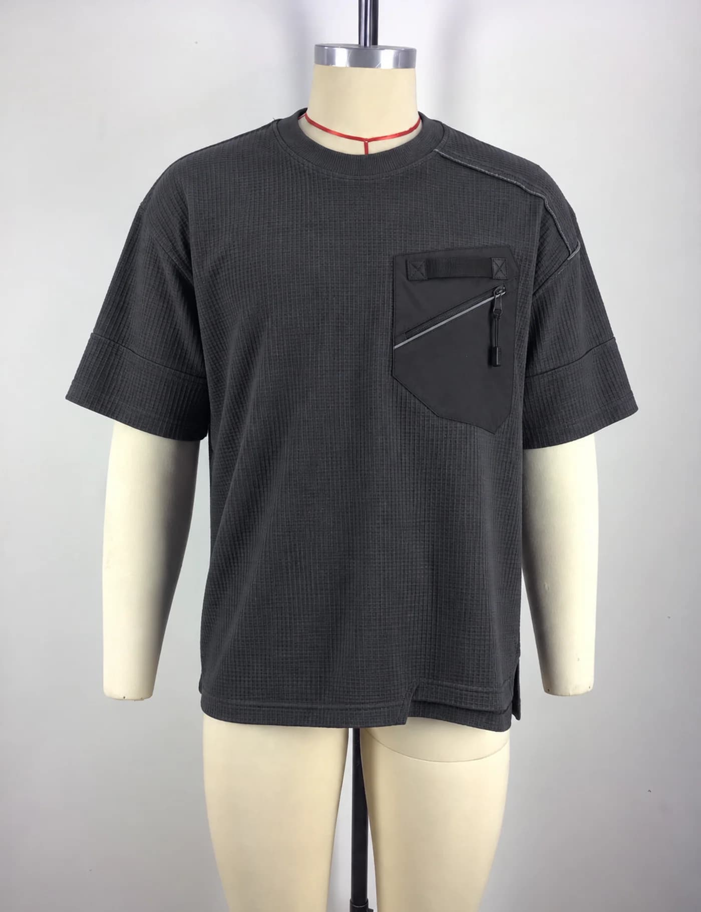 Actual zip-pocket textured t-shirt sample shown from the front on a mannequin