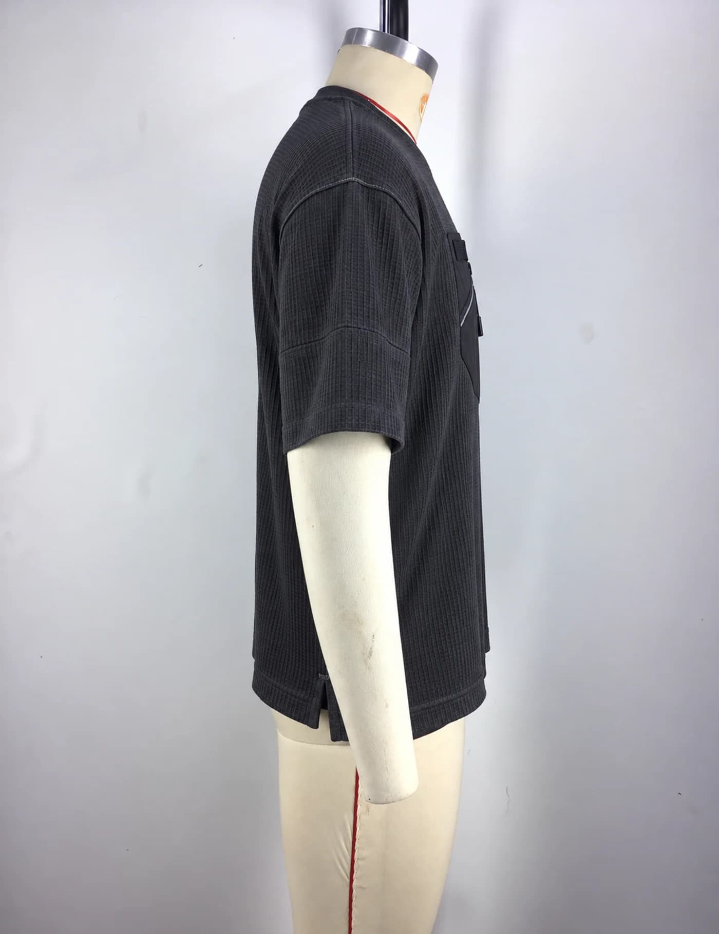 Actual zip-pocket textured t-shirt sample shown from the side on a mannequin